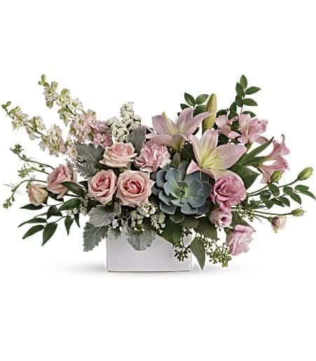Hello Beautiful Bouquet - Take their breath away with the beautiful hello that this bouquet brings! A wildly sophisticated array of pale pink roses and lilies with modern greens, it's perfectly presented in a simple white square vase. 