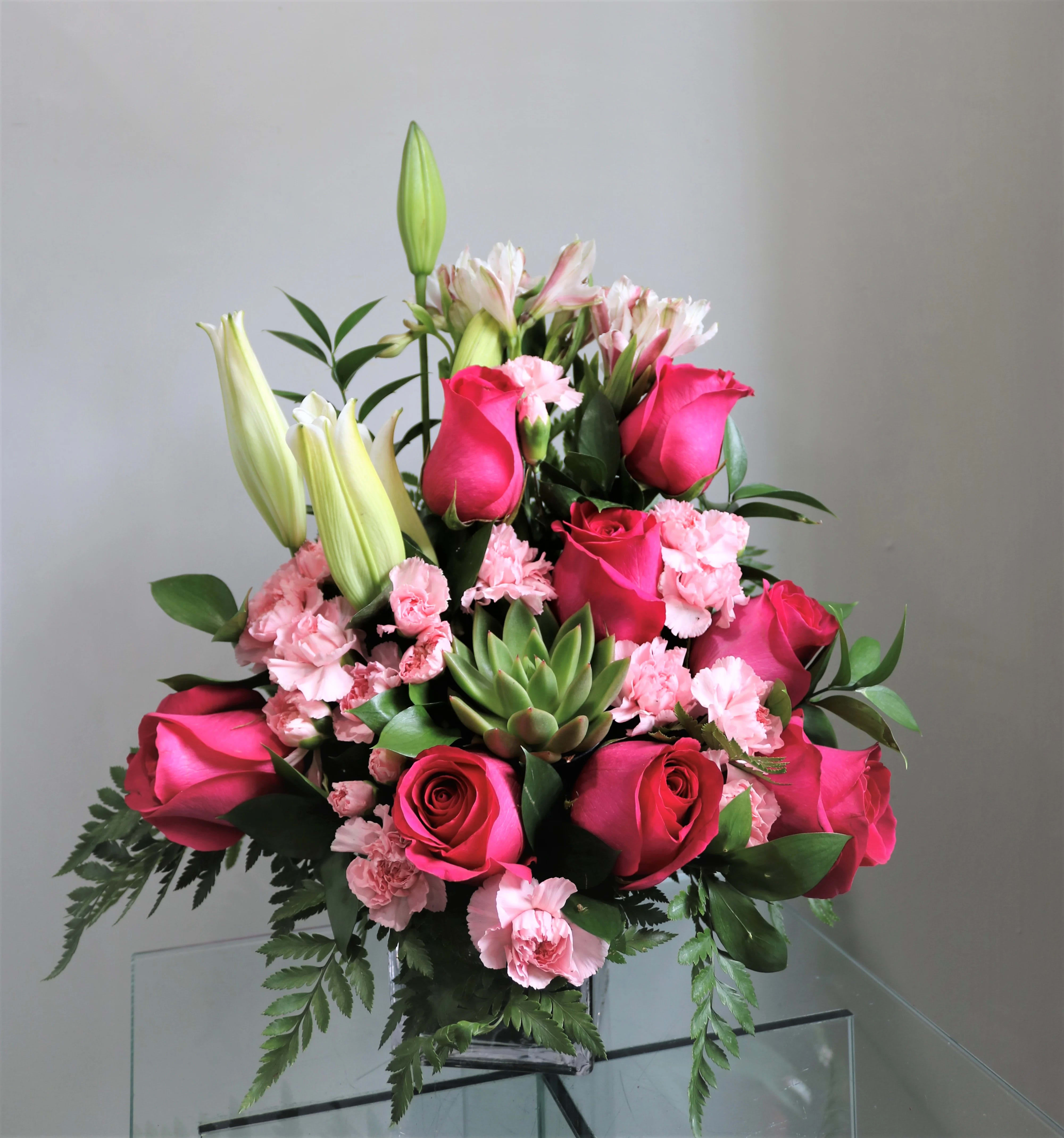 Sweet Succulent - A great gift for those who love flowers and plants! This beautiful arrangment of pink roses, carnations and alstomelias also included an adorable succulent for your recipient to keep! 