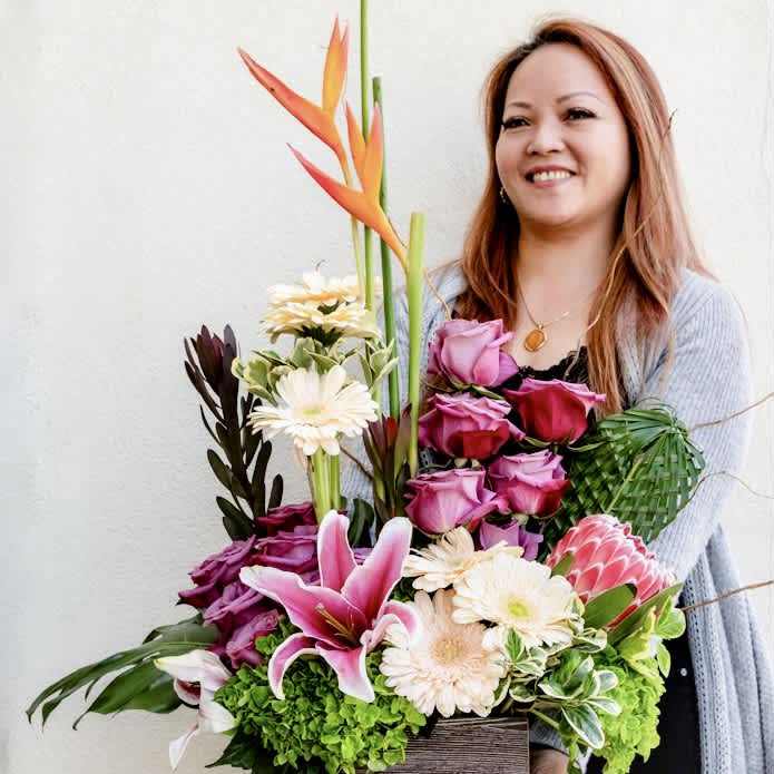 Exotic Elegance - Step into the world of Exotic Elegance! From the towering presence of majestic heliconias to the delicate allure of orchids, this bouquet is an absolute head turner!  Curated to showcase all the beauty that nature has to offer, this arrangement exudes sophistication that’s perfect to make a bold statement in your home or office.  Approximately 18” H x 12” W