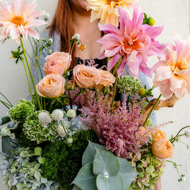 Spring Garden - Step into a blooming paradise with our Spring Garden Bouquet! Inspired by the vibrant blooms the season brings, this exquisite arrangement showcases a symphony of alluring spring flowers to send the joy your loved ones so very much deserve.   Approximately 20” D