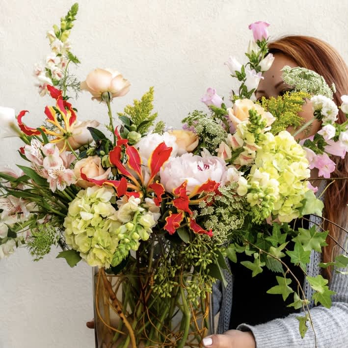 Whimsical Spring - Step into the season’s magical wonderland with our enchanting “Whimsical Spring” bouquet. This ethereal arrangement transports you to a realm of exotic florals in vibrant colors capturing the essence of a fairy-tale garden in full bloom.  Approximately 16” D