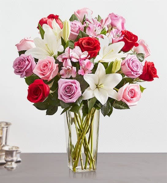 Just for Mom - A beautiful and colorful mix of asiatic lillies and roses that is sure to put a smile on Mom's face. The Regular size will include 4 stems of assorted lillies and 6 assorted roses roses The Deluxe is shown with 5 stems of lillies and 12 roses