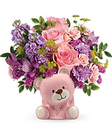 Beautiful Arrival Bear Bouquet - Congratulate the new parents with this sweet bouquet of pink roses and delightful ceramic bear keepsake! Pink roses, pink spray roses, purple alstroemeria, lavender carnations, lavender stock, and raspberry sinuata statice are arranged with bupleurum and huckleberry. Delivered in a pink Bundle of Love Bear.