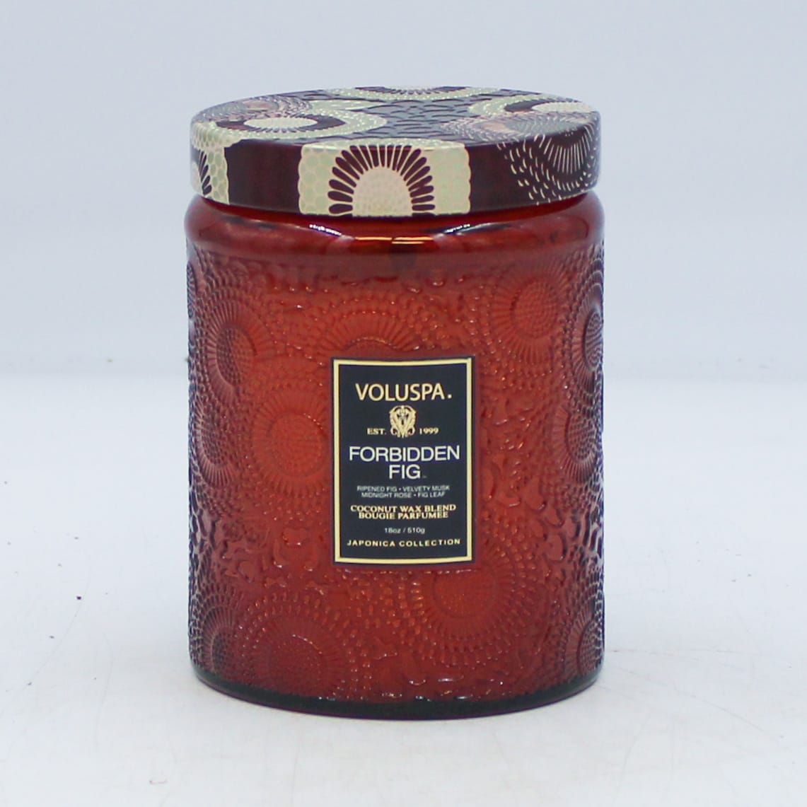 VOLUSPA Forbidden Fig  - DESCRIPTION  Notes of Ripened Fig, Velvety Musk, Midnight Rose &amp; Fig Leaf. Fragrance Description Unearth the pure magnificence of the wild fig tree. Rooted down in the dry sun-drenched soil, smooth white bark unfolds with fragrant facets of lush green leaves. This matriarch of the orchard is crowned with succulent dark fruits, filled with coveted sweet nectar and armed with sophisticated woody stalks. The rustling wind sweeps up the essence of plump wild berries and fallen crushed leaves, leaving you with an aromatic fragrance so sweet and alluring that it earns its name - Forbidden Fig.