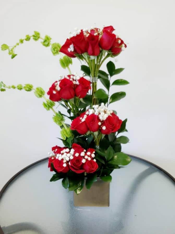 Roses Stairs Roses Stairs - luxury arrangement with 36 red roses and bells of Ireland y a cube silver vase Flowers and similar colors