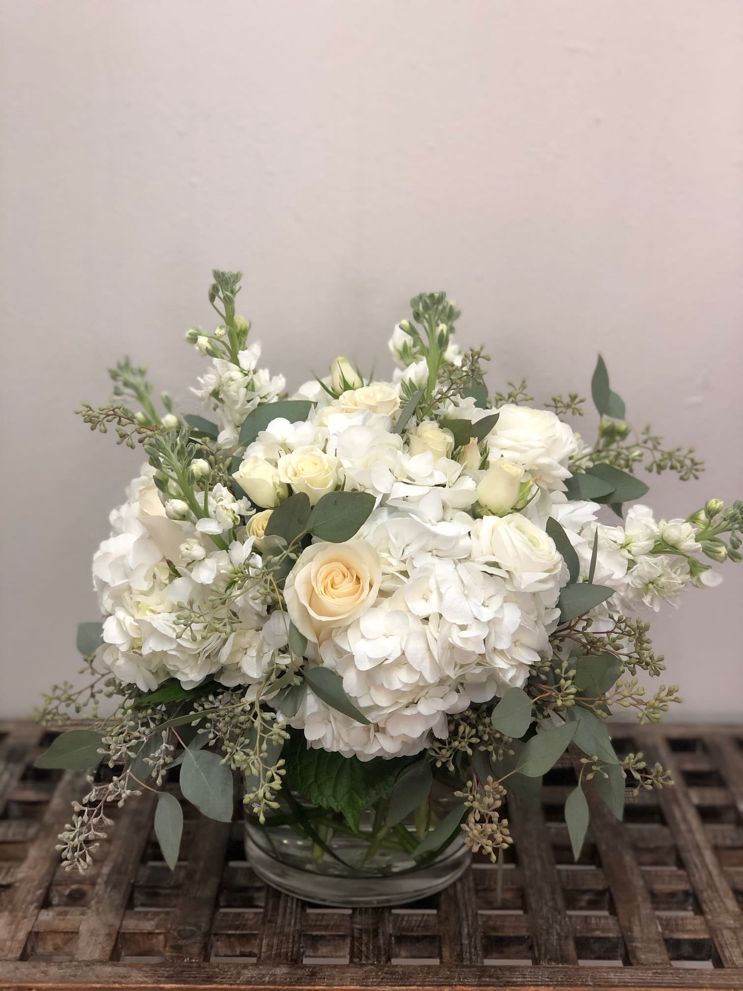 Cloud Bouquet Cloud Bouquet - Assortment of all white flowers, pretty soft greenery in a low vase. Flowers may vary depending on availability.