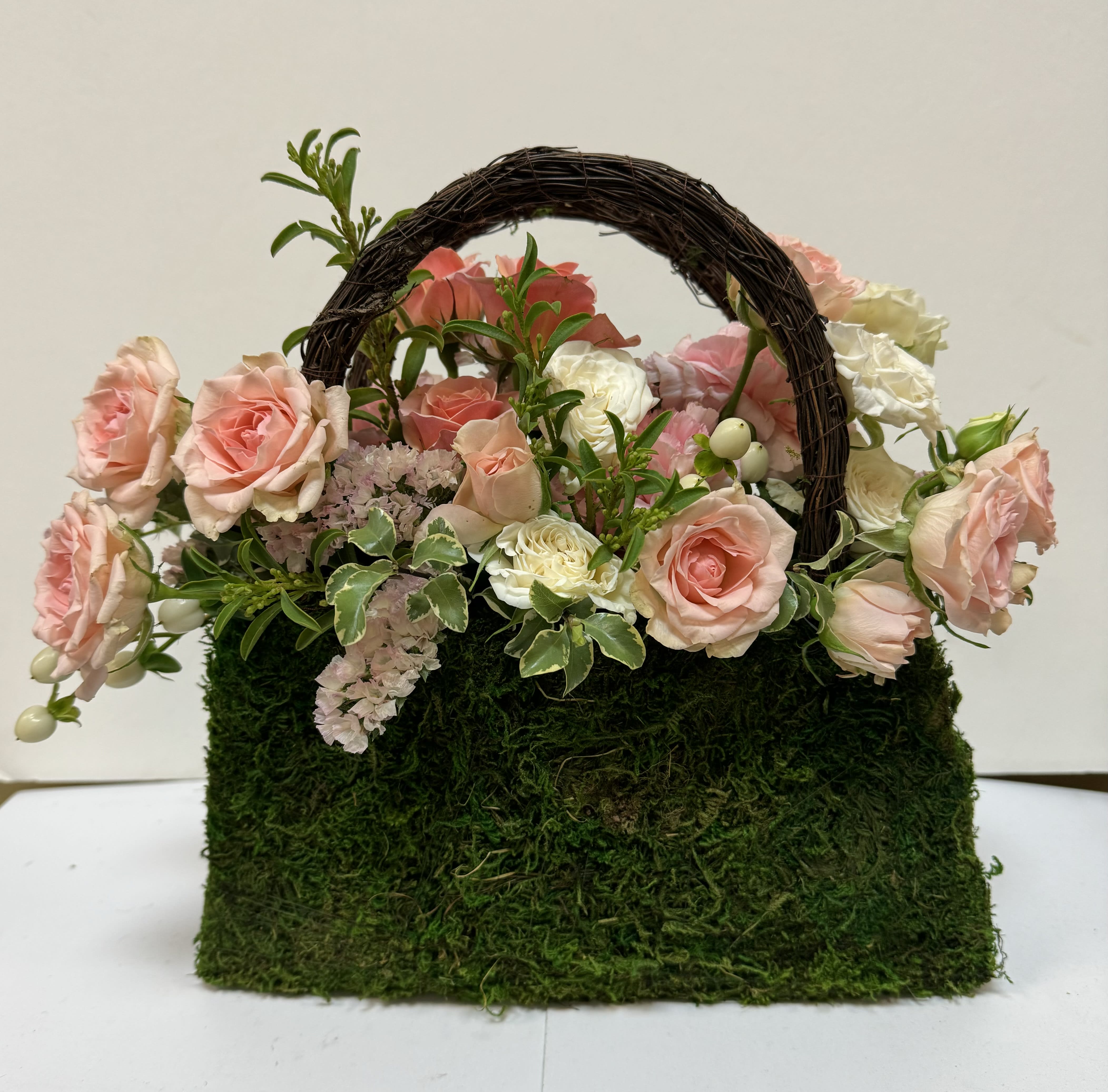 Girl’S Best Friend - What girl doesn’t like a great purse….. especially when it’s filled with fresh florals!  This sweet moss purse is filled with beautiful roses and seasonal florals . 