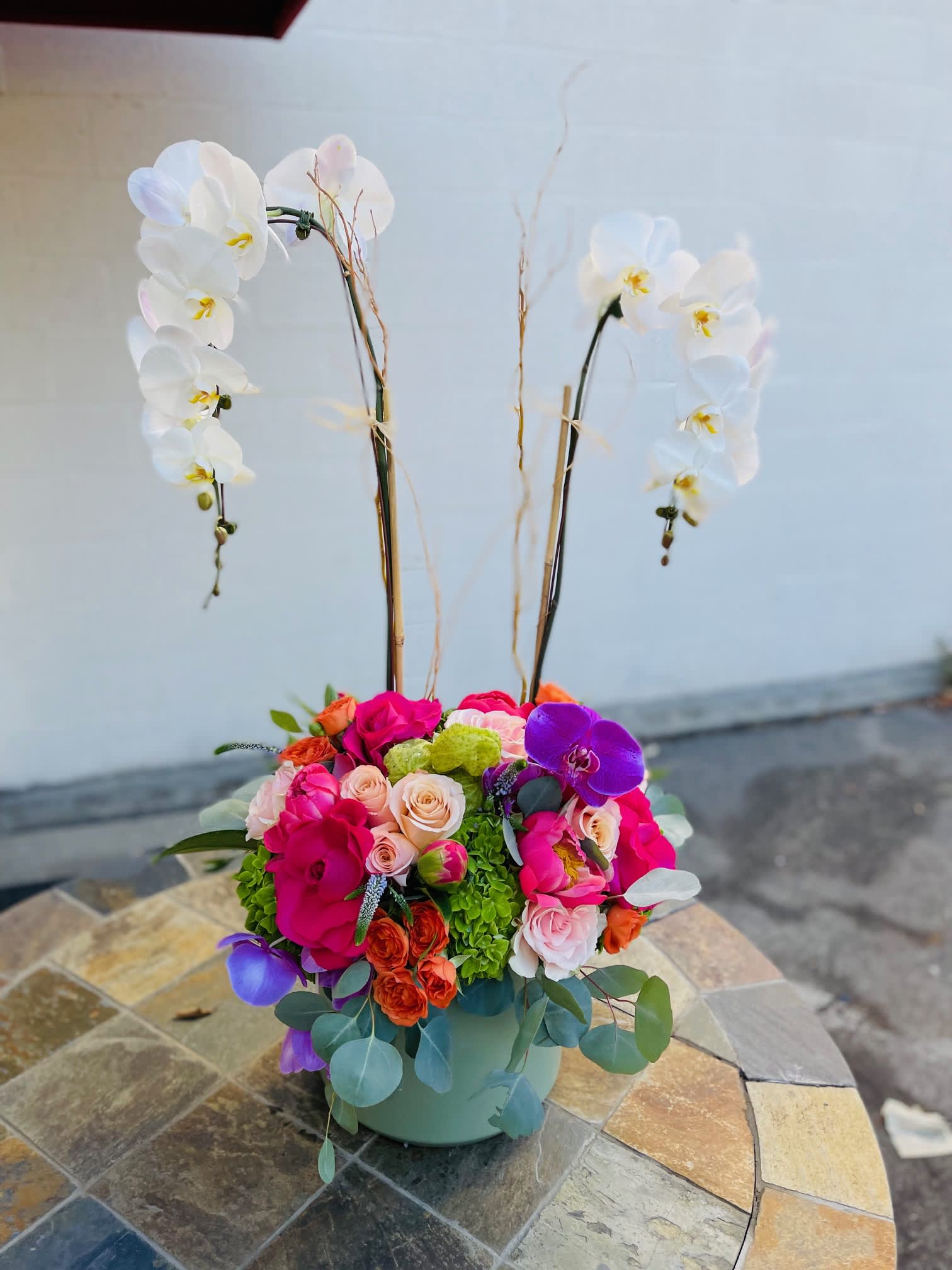 x2 Large Orchids with flowers and Peonies. - This stunning arrangement with live large orchids with flowers at the bottom in a large ceramic vase. Lush garden flowers and Peonies. 