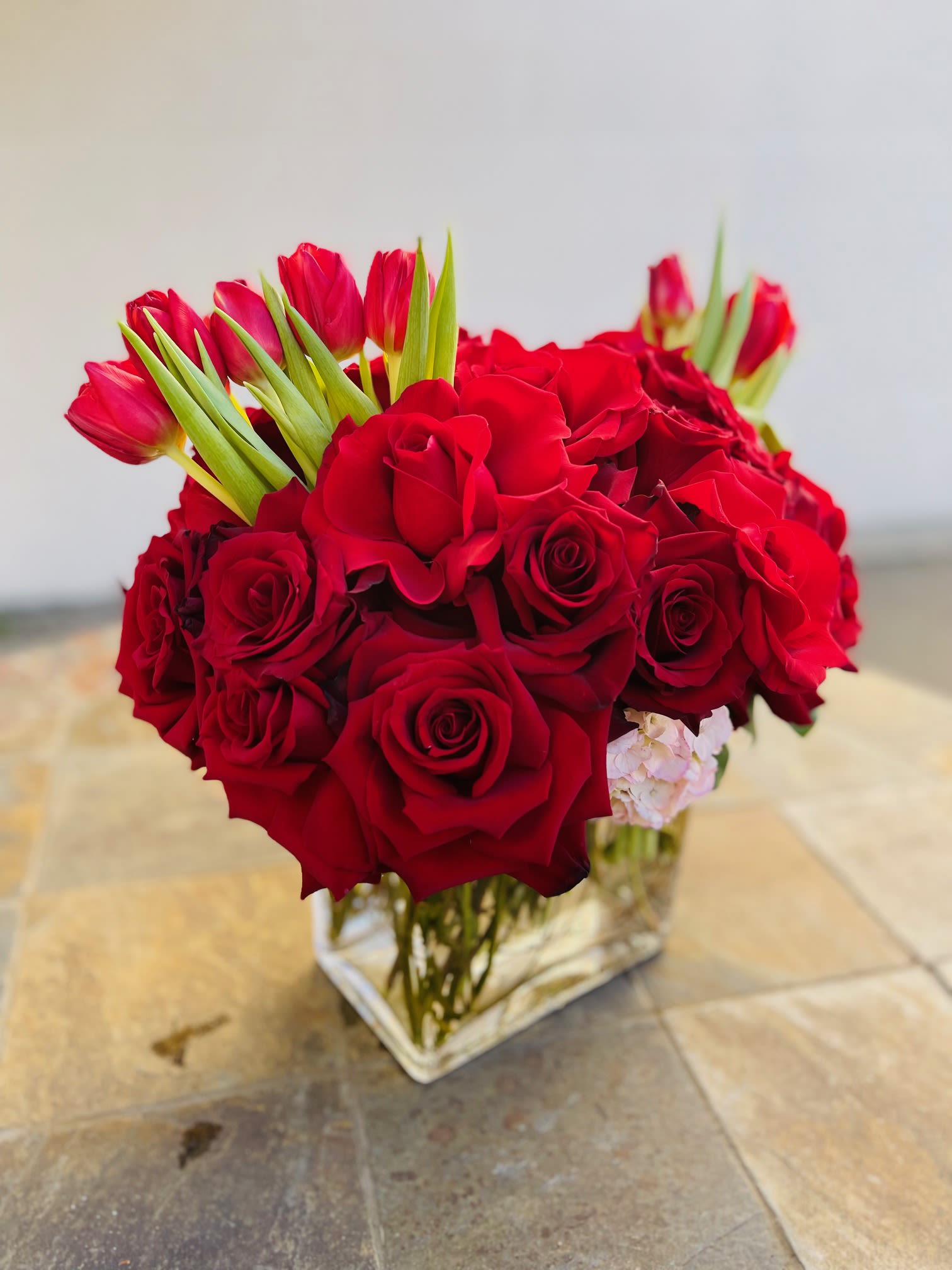 Red pave - Red roses, Pale pink Hydrangeas and touch of red tulips in a 6x6 cylinder vase.