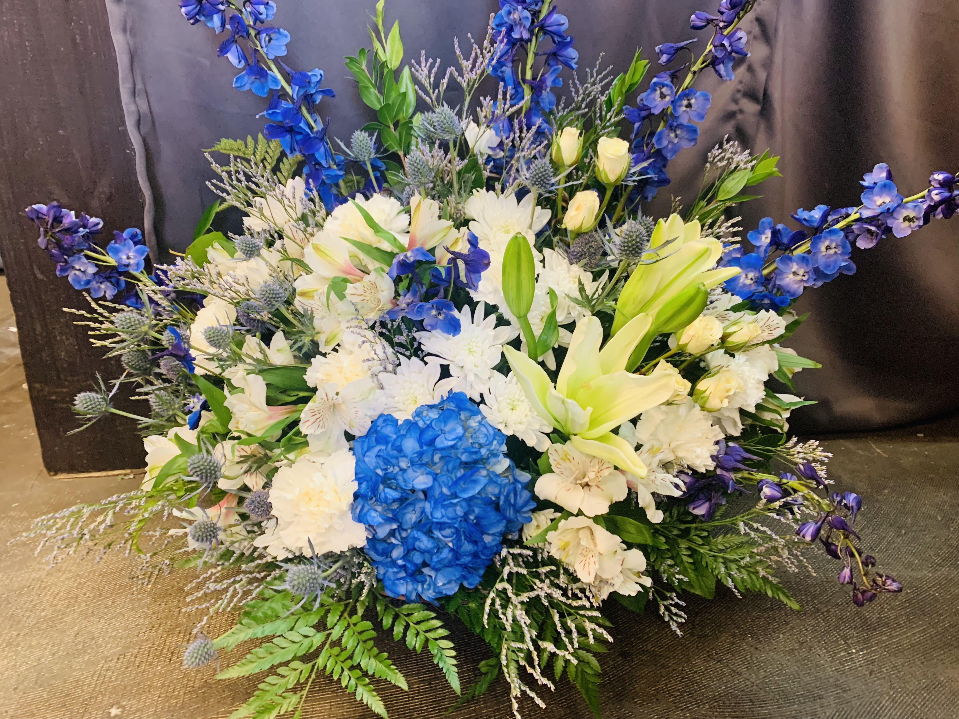 Blue for you - Brighten the home with the peace and beauty of a bright blue sky. This beautiful bouquet pairs pure white flowers with deep blue blooms in a gorgeous blue basket  Blooms such as blue hydrangea, crème roses, graceful white oriental lilies, white alstroemeria, a white disbud mum, purple statice and lavender limonium are accented by seeded eucalyptus and salal in a stunning cobalt blue glass vase. Orientation: One-Sided  SUBSTITUTION POLICY Always deliver the freshest flowers! Please note the bouquet pictured reflects our original design.  If the exact flowers or container in this arrangement are not available, our local florists will create a beautiful bouquet with the freshest available flowers.