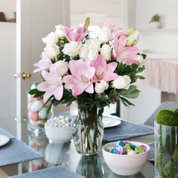 Always a Lady -Pink Lily and White Roses - She'll always be your #1 lady. Remind her just how special she is - send a sensational gift she'll never forget. This beautiful bouquet of fragrant pink lilies and lush white roses is sure to make an impression! One dozen white roses are mixed with pink asiatic lilies and variegated pittosporum in a classic clear glass rose vase. Standard -12roses Deluxe -18 rose Premium-24 roses Orientation: All-Around