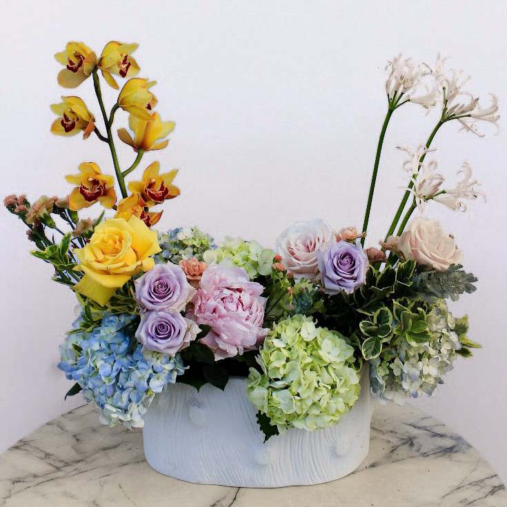 Mythical Spring - Introducing our enchanting “Mythical Spring” creation! A floral masterpiece that transcends the ordinary into a magical bouquet curated with the freshest blooms that transports you to a realm of myth and wonder. Perfect gift for all occasions!  Approximately 21” D