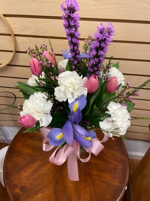 Passion Fruit - Cut arrangement with pink tulips, purple iris, purple liatris, white carnations, and wax flowers.
