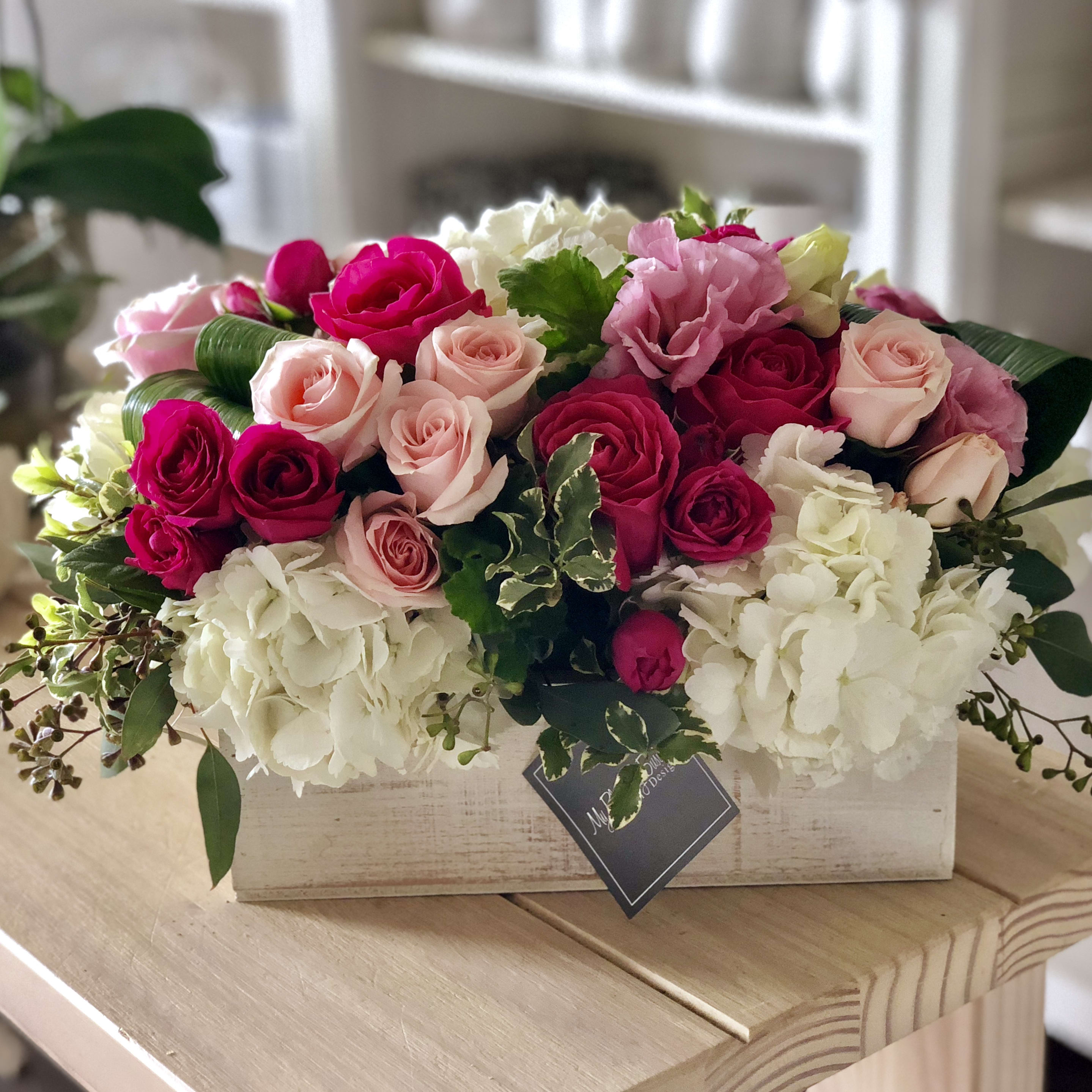 Expressions of Pink - Expressions of Pink brings bright color and beauty to any home or office. Our rustic wooden box is artfully arranged with a selection of vibrant pink florals, including stunning white hydrangeas and beautiful pink roses. Sure to make a lasting impression, this arrangement makes the perfect addition for special occasions or just because! Not only will Expressions of Pink generate smiles, but the natural scents from the flowers will be sure to relax and bring happiness into the atmosphere. Make your next sentiment even more special when you express it with Expressions of Pink!