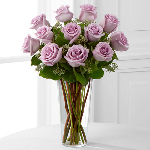 Lavender Rose Bouquet - An enchanting bouquet of lavender roses paired with seeded eucalyptus in a stylish glass vase.