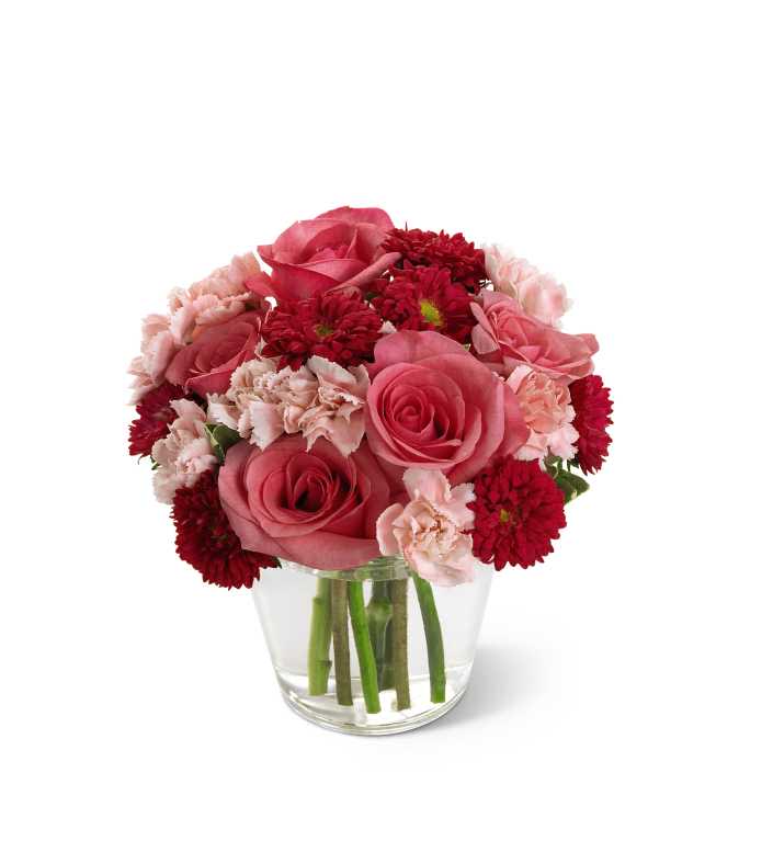 The FTD Precious Heart Bouquet - The FTD Precious Heart Bouquet is a warm and heartfelt way to convey your deepest sympathies. Radiant hot pink roses, deep red matsumoto asters and light pink mini carnations are lovingly arranged in a clear round glass vase to create the perfect way to show how much you care in this time of grief and loss.