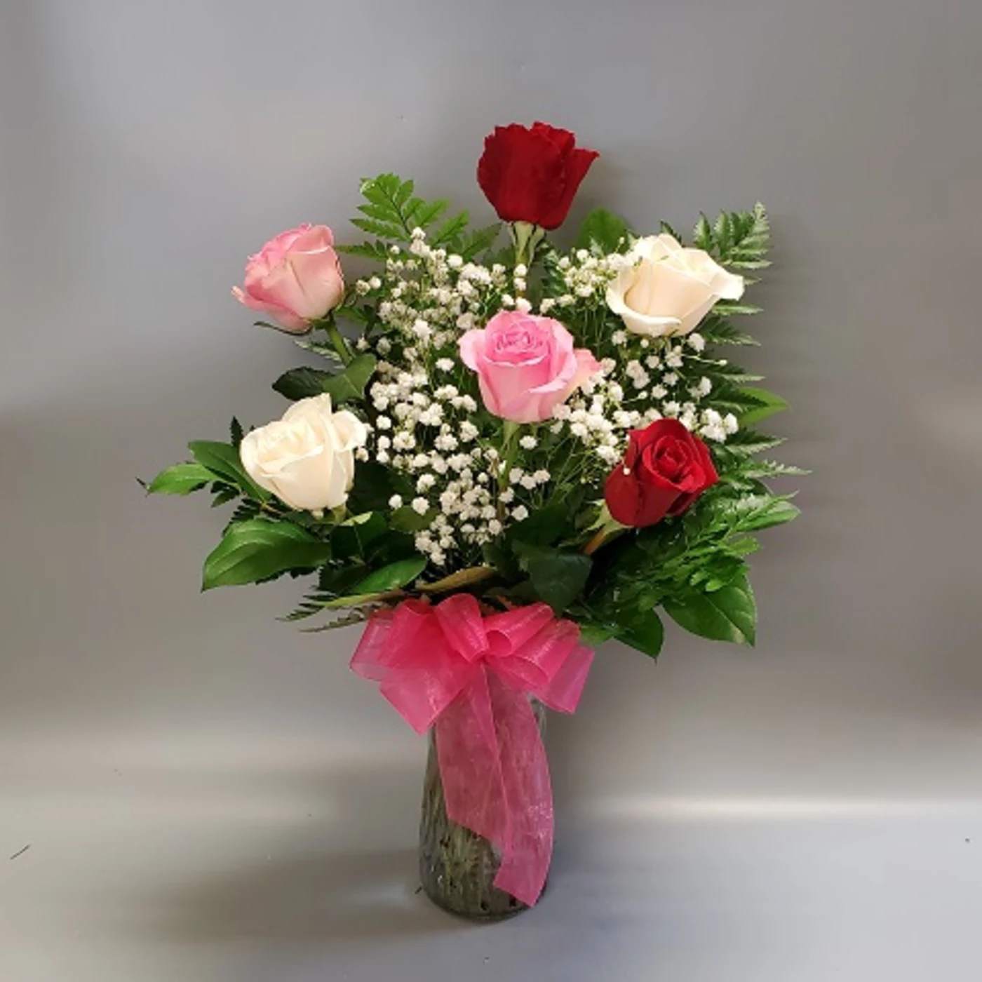 Shades of Pink and Red - EXCLUSIVE She'll be blushing for sure when our beautiful bouquet of pink and red long-stem roses arrives at the door! Hand-gathered by our expert florists in a vase, we can't think of a more colorful way to express yourself to someone very special. Gorgeous bouquet of premium long-stem pink and red roses, accented by fresh waxflower and salal Artistically arranged by our expert florists in a stylish glass gathering vase.
