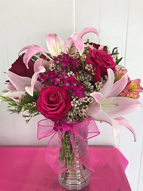 Sweet Pink Roses Bouquet - The &quot;Sweet Pink Roses Bouquet&quot; is a beautiful flower arrangement in a clear base. This perfect any special occasion. Comes with 6 hot pink, 3 stem light pink lillies, white wax, sweet hot pink William, 3 stem alstromeria and greenery. 18&quot; H x 12&quot; W approx.
