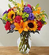 The FTD Best Day Bouquet - The Best Day™ Bouquet is ready to create a moment your recipient will always remember! An instant mood booster with it's mix of bright bold colors, this gorgeous fresh flower arrangement brings together sunflowers, hot pink roses, purple double lisianthus, orange LA Hybrid Lilies, yellow snapdragons, green button poms, and lush greens to make this day, their best day. Presented in a clear glass vase, this fresh flower arrangement is made just for you to help you send your warmest birthday, congratulations, or get well wishes to your favorite friends and family. GOOD bouquet is approx. 15&quot;H x 12&quot;W. BETTER bouquet is approx. 18&quot;H x 13&quot;W. BEST bouquet is approx. 18&quot;H x 14&quot;W. EXQUISITE bouquet is approx. 20&quot;H x 15&quot;W.