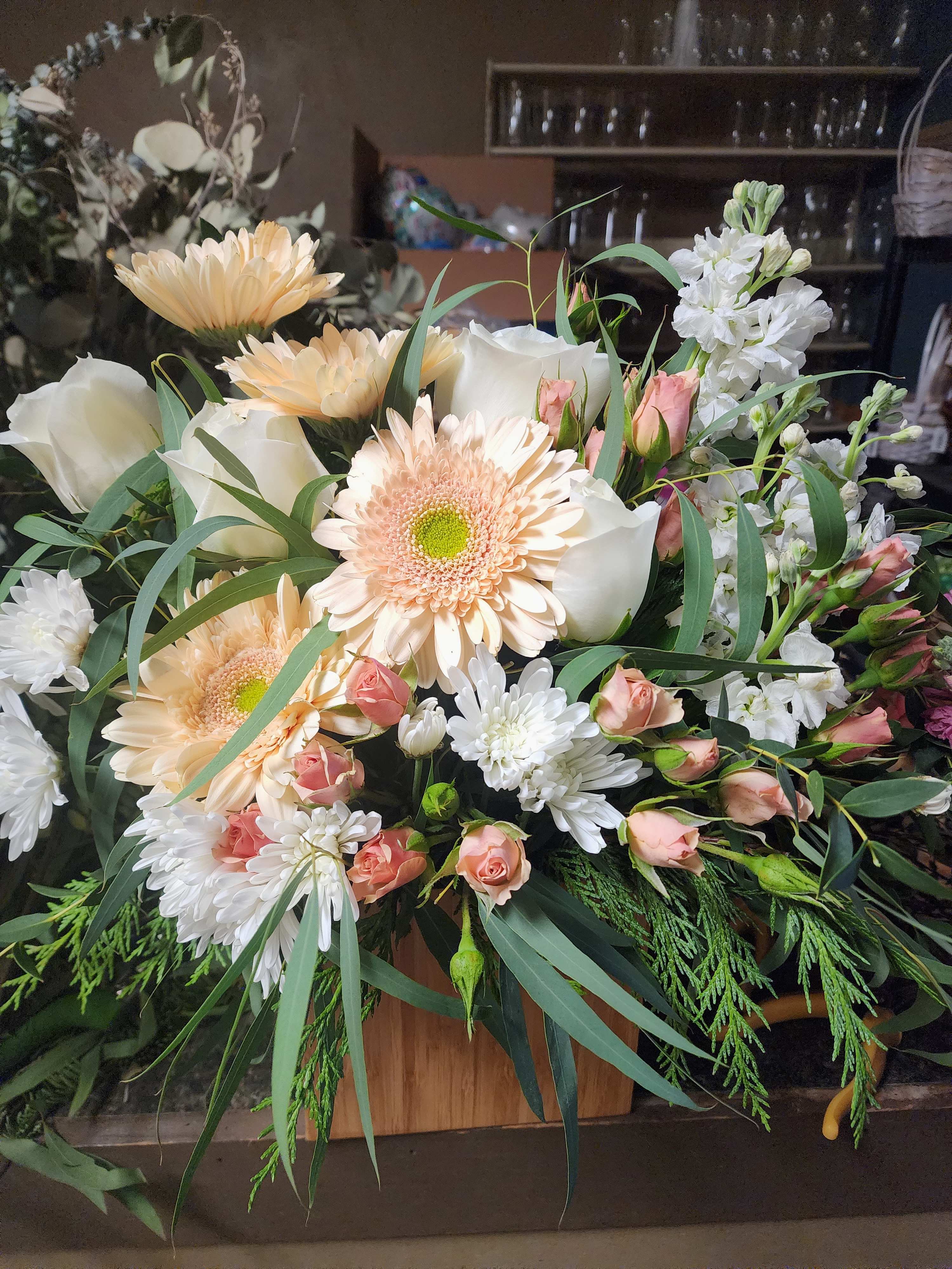 Peachfully Yours Peachfully Yours - Perfect for the office, get well, or funeral service. Soft peach and white hues in a wood box. *winter greens subject to availability