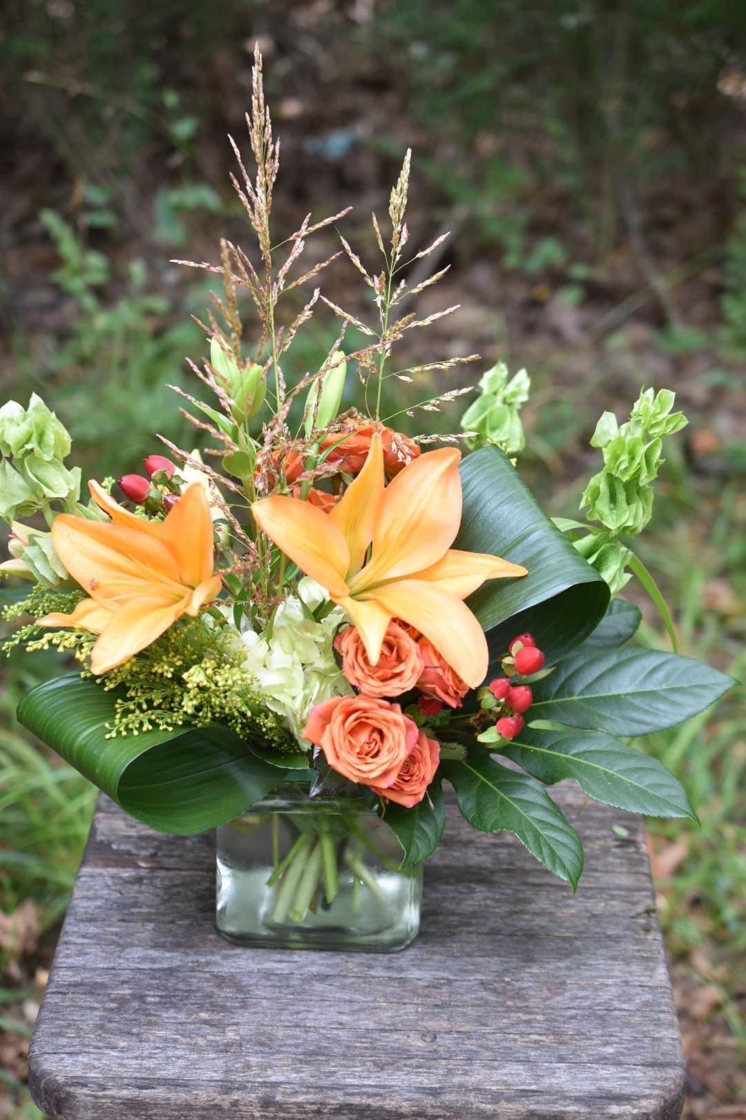 In an Autumn Daze - This beautiful autumn arrangement is bright and cheerful and perfect for any occasion. This design was named by one of our followers, Cam Lee Aldridge, and is sure to cheer up your loved one with its happy colors!