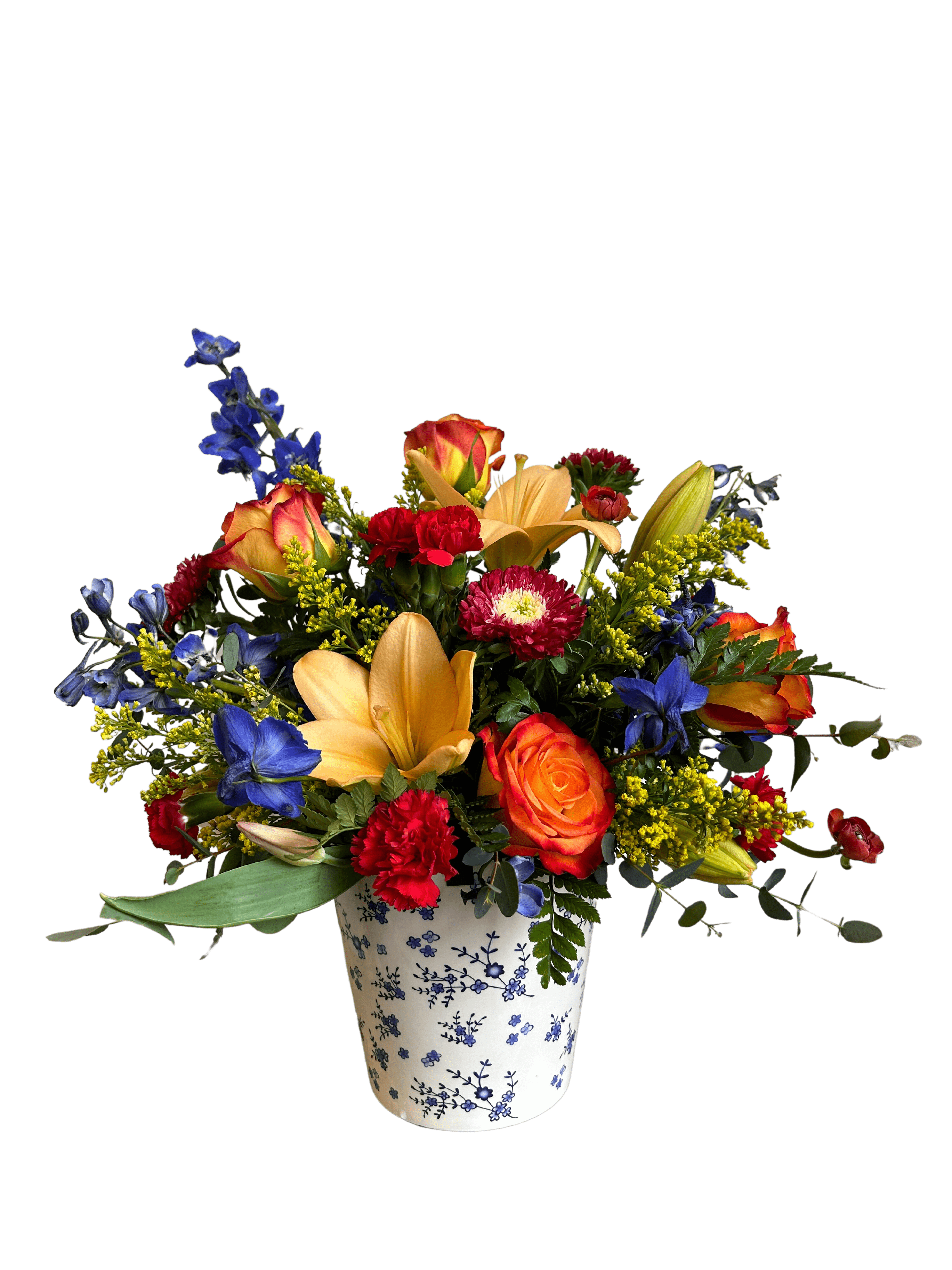 Mamma Mia - A beautiful Blue and White Ceramic container filled with bright blooms of delphinium, roses, carnations, lilies, matsumoto asters and a variety of beautiful greenery