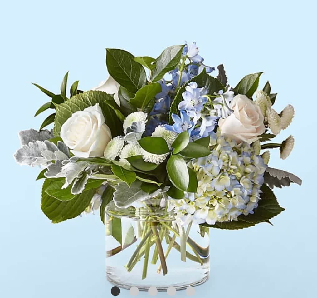 Clear Blue Skies Bouquet - Let this uplifting arrangement be reminders of the clear skies ahead. Capturing the feeling of hope that a new day brings, this bouquet is composed of voluminous hydrangea blooms and vibrant belladonna delphinium to refresh their mood.