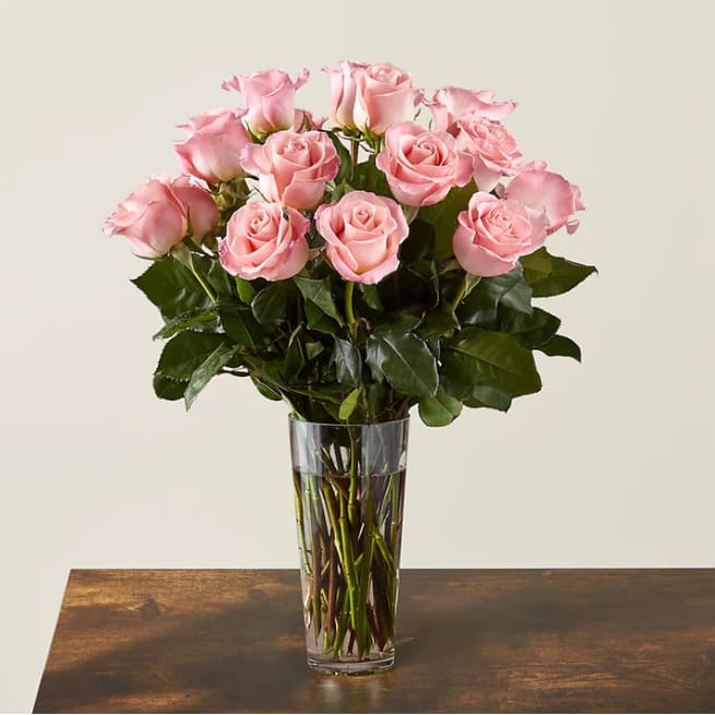Long Stem Pink Rose Bouquet - Enjoy the classic beauty of the rose with a playful twist in our Long Stem Pink Rose Bouquet. This arrangement features all pink roses that will look especially pretty in the hands of those you cherish most.  Please Note: The bouquet pictured reflects our original design for this product. While we always try to follow the color palette, we may replace stems to deliver the freshest bouquet possible, and we may sometimes need to use a different vase.