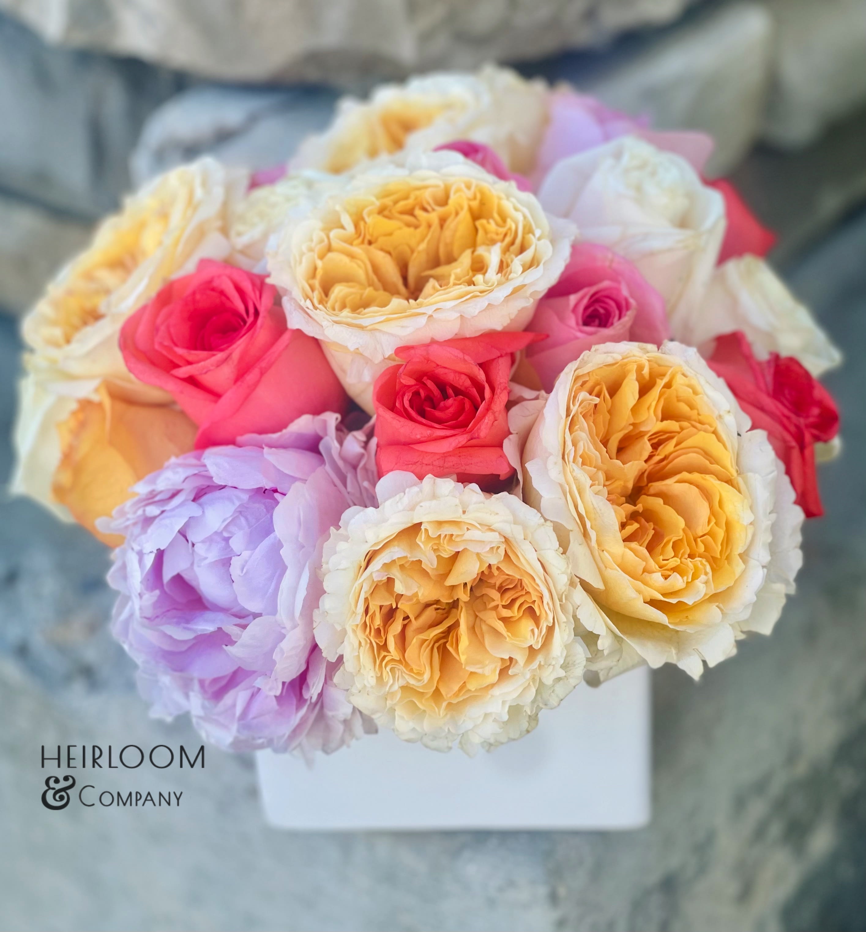 Peony Cakes Peony Cakes - Peonies aren't dessert, but if they were - this one takes the cake! A white cube filled with the most vibrant and tasteful peonies and premium garden roses. Everyone deserves a cheat day.