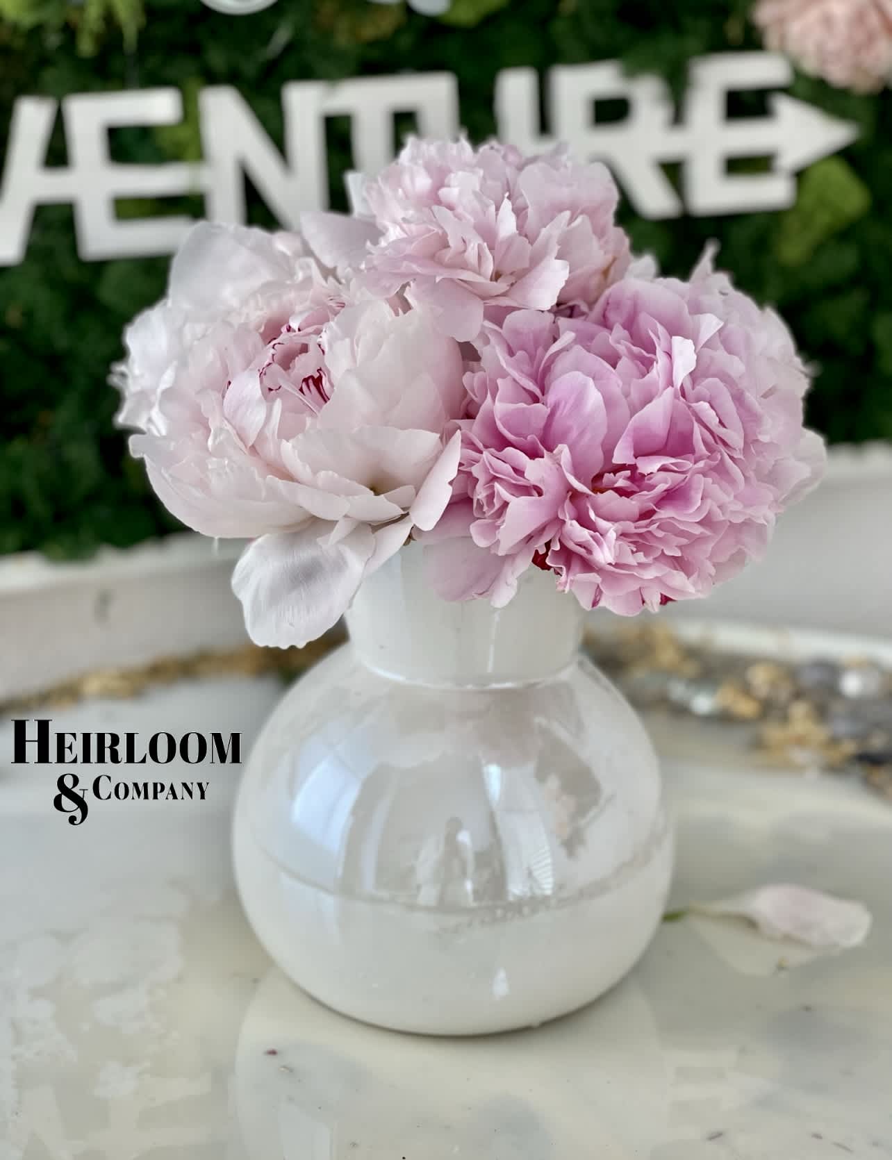 Enchanted Peony arrangement - An iridescent bubble bowl overflowing with delicate pink and blush peonies. Embrace pure femininity with this adorable arrangement, designed to captivate hearts and evoke a sense of whimsy. Each petal delicately placed, creating a symphony of soft hues that dance in the light. Perfect for adding a touch of elegance to any space or occasion, this darling creation promises to enchant and delight. Elevate your décor with a dash of romance and charm, courtesy of our blooming masterpiece.