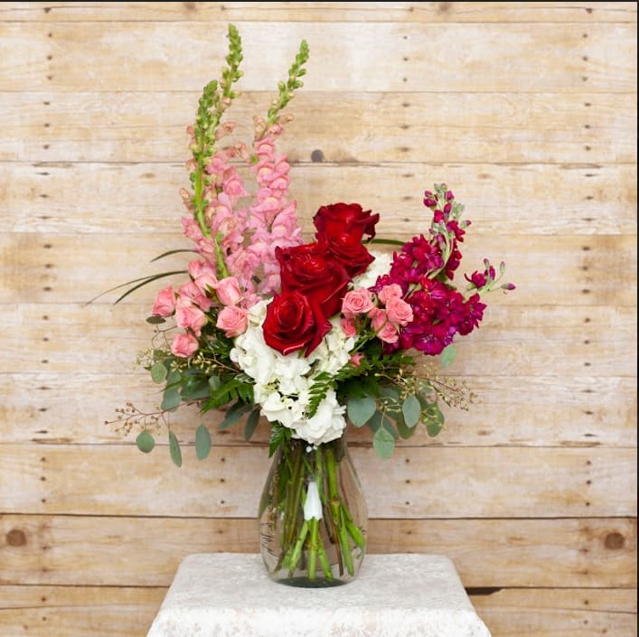 Candy Kingdom - A beautiful display of roses, stock, snapdragons and hydrangeas in a bed of eucalyptus and assorted greens.  This show stopper is sure to be a winner.  
