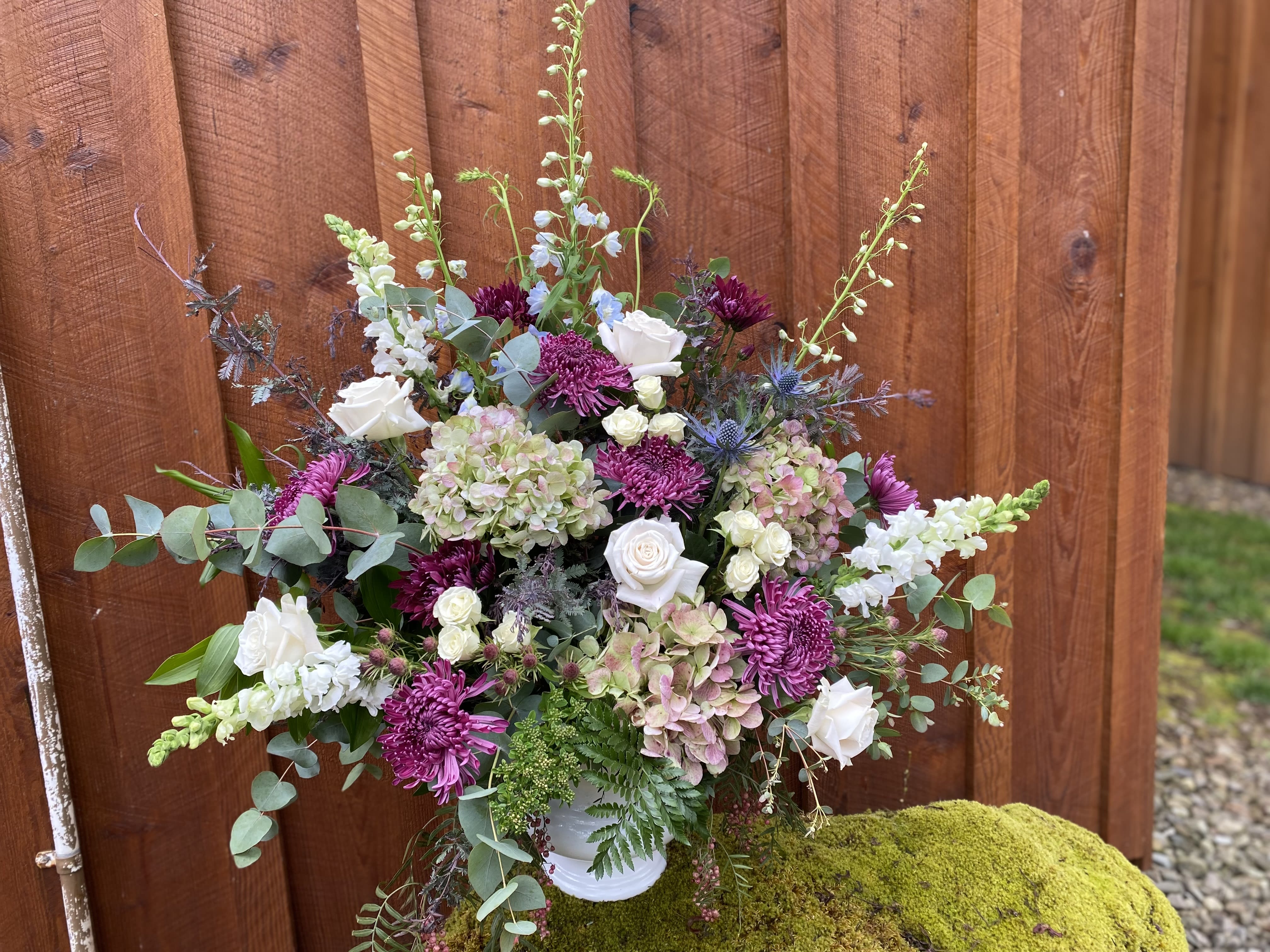 Rustic garden floor basket  - Large arrangement suitable for funeral or home . Approx 24” tall. Premium blooms such as hydrangea, roses, Snap dragons or Larkspur , Delfinium,  and mums . Shown as deluxe and premium.  