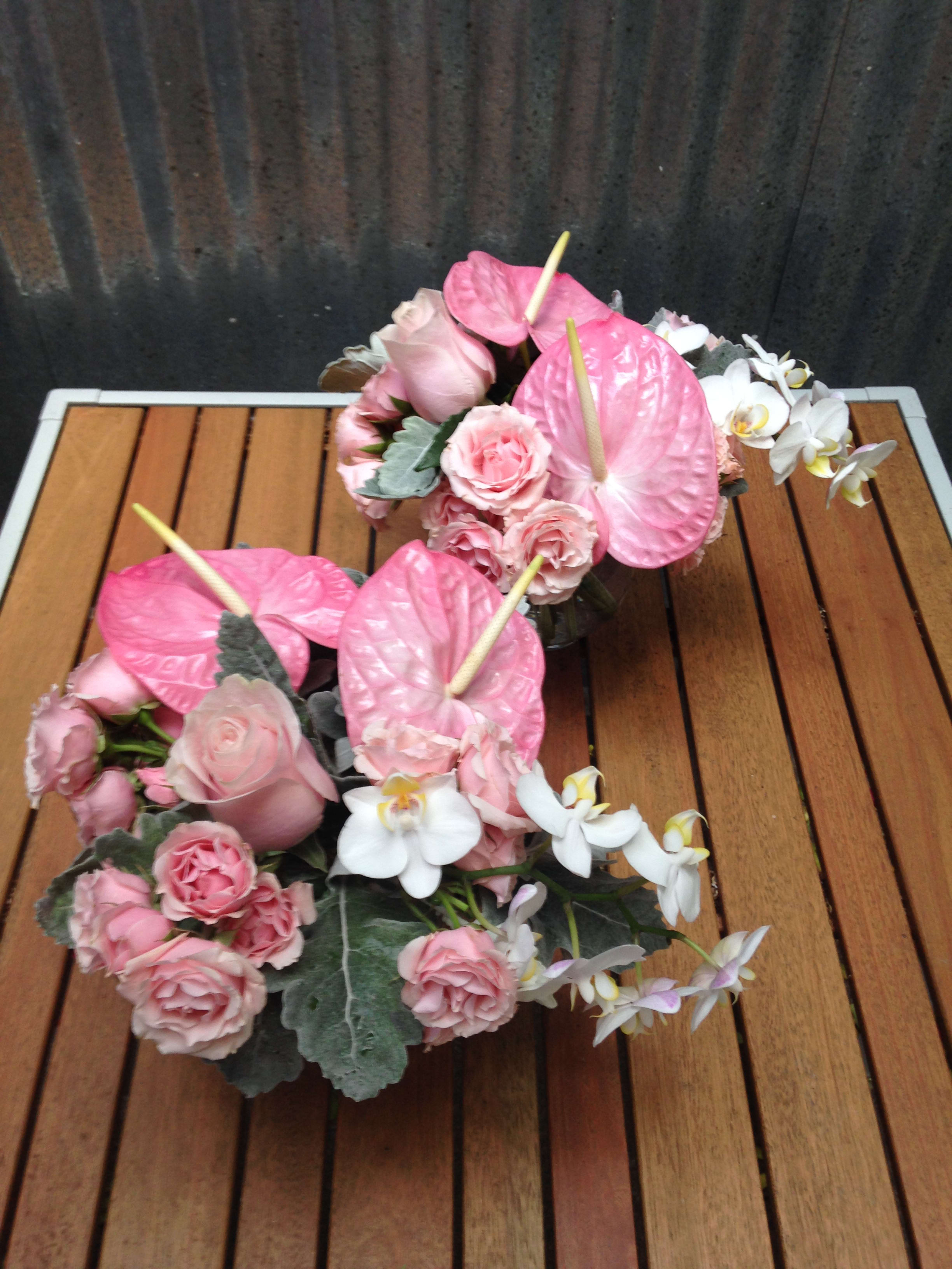 Angelic Anthurium Centerpieces. {PRE ORDER ONLY} Angelic Anthurium Centerpieces. {PRE ORDER ONLY} - A sophisticated statement for a party or event. Featuring elegant pink anthurium, roses, and orchids. Featured Arrangements: $300.00 for two; $155.00 each