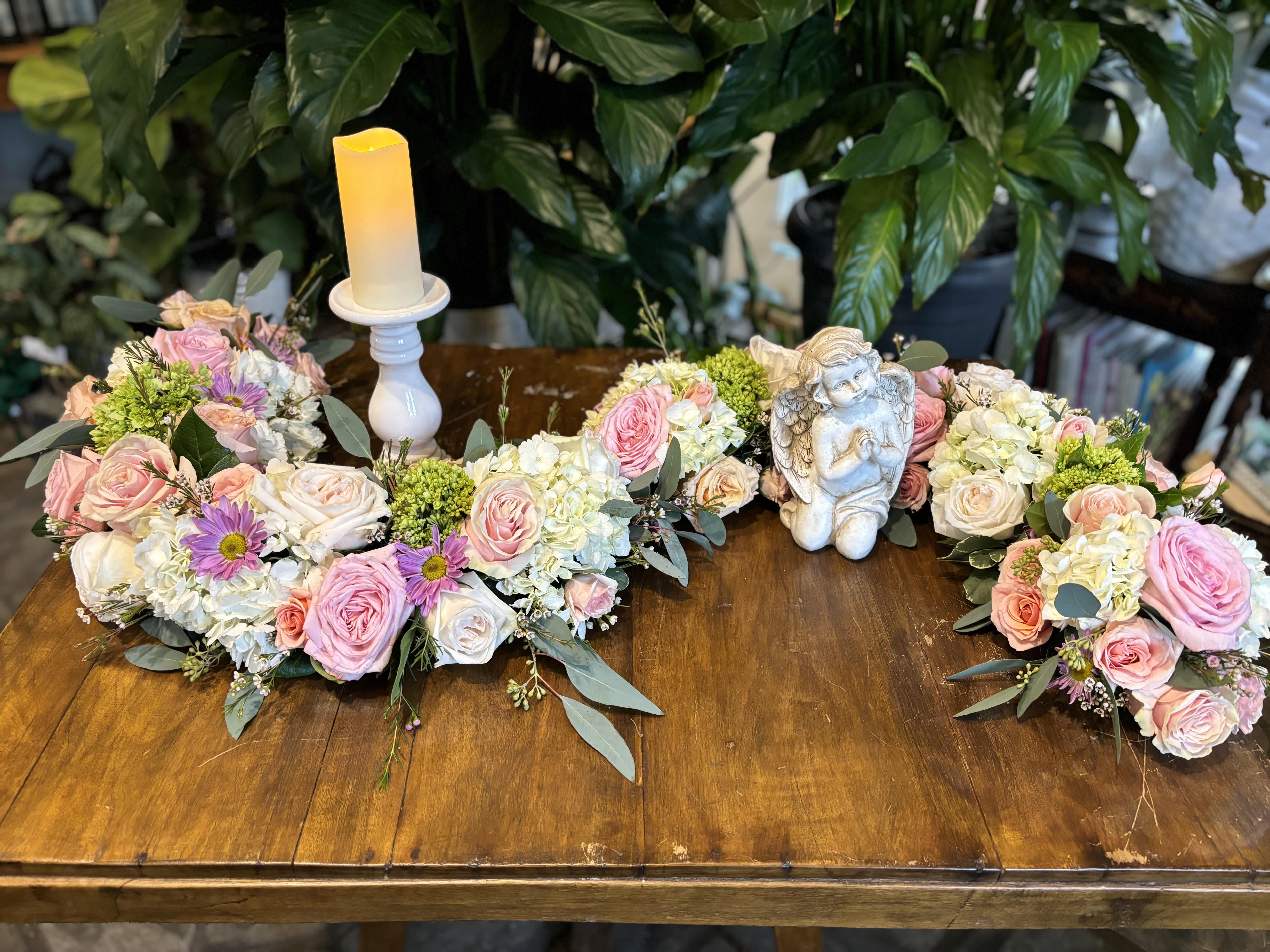 "S" Shaped Display "S" Shaped Display - A beautiful collection of garden flowers shaped to accentuate your loved one's urn and their photograph or candles. Flowers and colors can be substituted based on your preference.