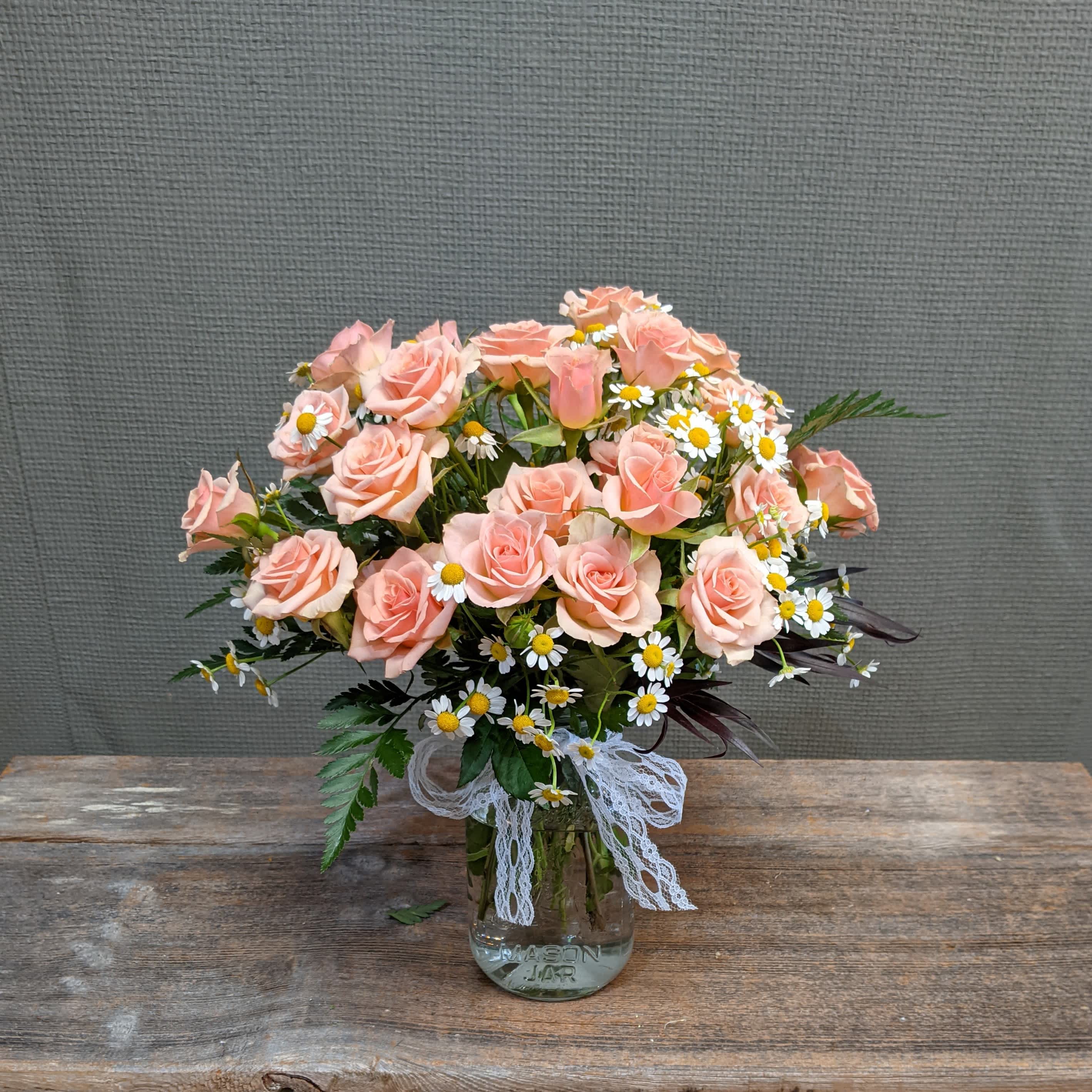 Joyful Spray - This arrangement of spray roses is a joy to give and to get. The small spray roses are as fun as they are beautiful and together with daisy matricaria make a whimsical design your mom is sure to love. It is set in a mason jar which is perfect for breakfast in bed, or upgrade to Premium for a larger centerpiece for family dinner. Please let us know if you have color requests in the special instructions.