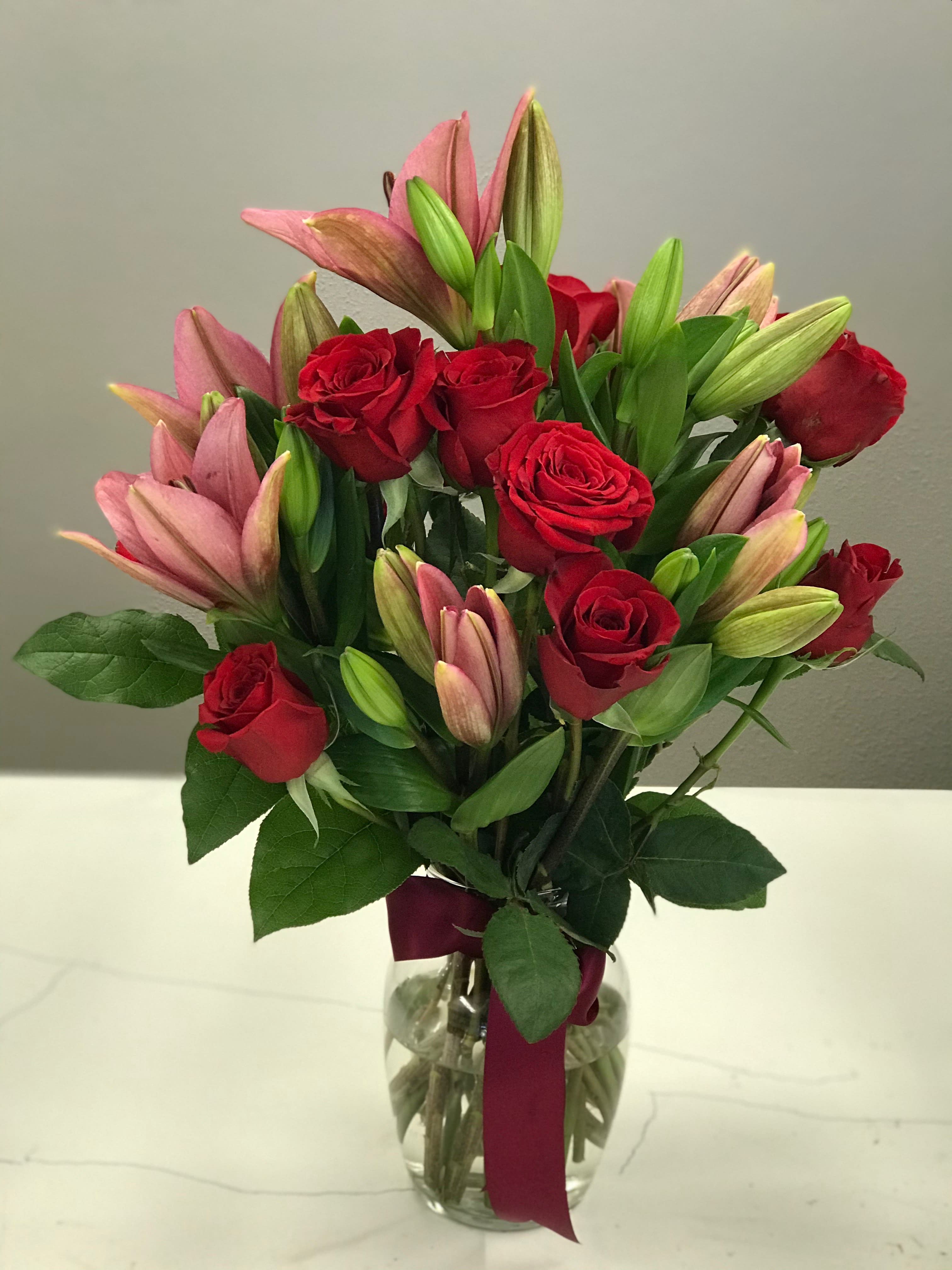 Roses and Lilies - A bouquet of Red roses and pink lilies is a classic and elegant way to I Love You. 