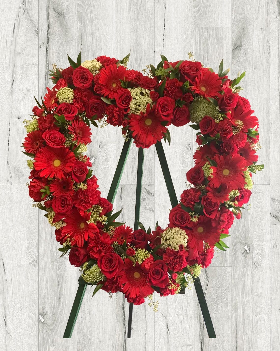 Tender Thoughts Heart-Shaped Wreath - When someone so dear passes, a standing tribute is a fitting way to pay respects. Our impressive hart-shaped standing spray arrangement, meticulously handcrafted by expert florists with red roses, gerbera daisies and carnations, is a lush, full presentation that makes for a proud and respectful commemoration.