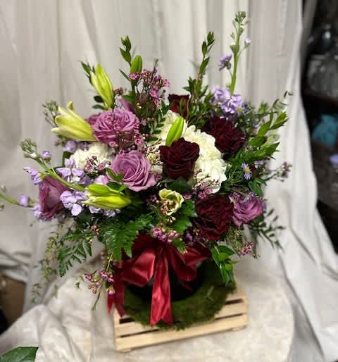Blooming Box - A blooming arrangement of purple and red roses with accents of hydrangea and stock. There is so many details to love in this arrangement