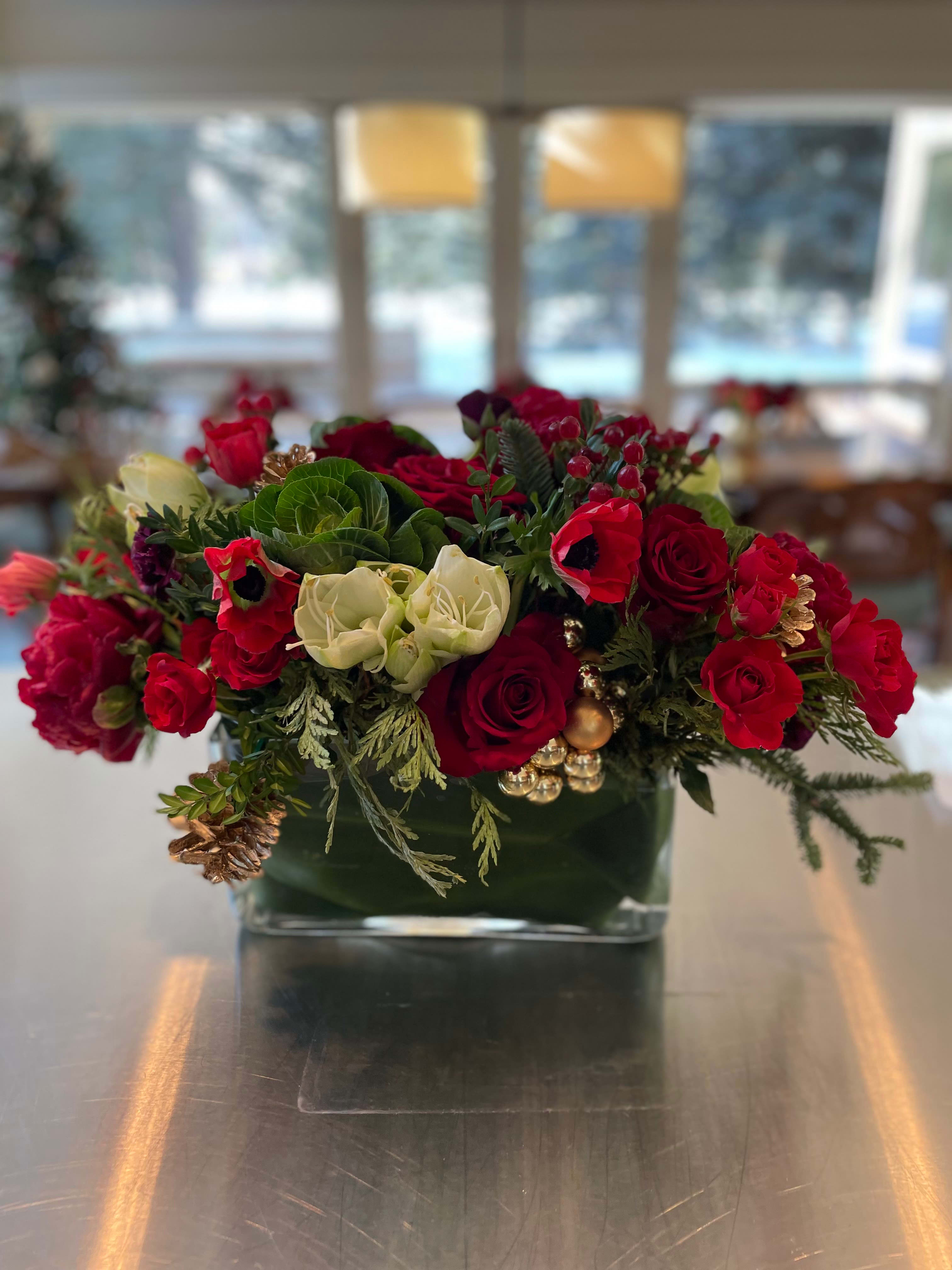 Holiday Feels - Holiday feels with reds, white and pine cones in 5x5 clear vase with ti leaf 