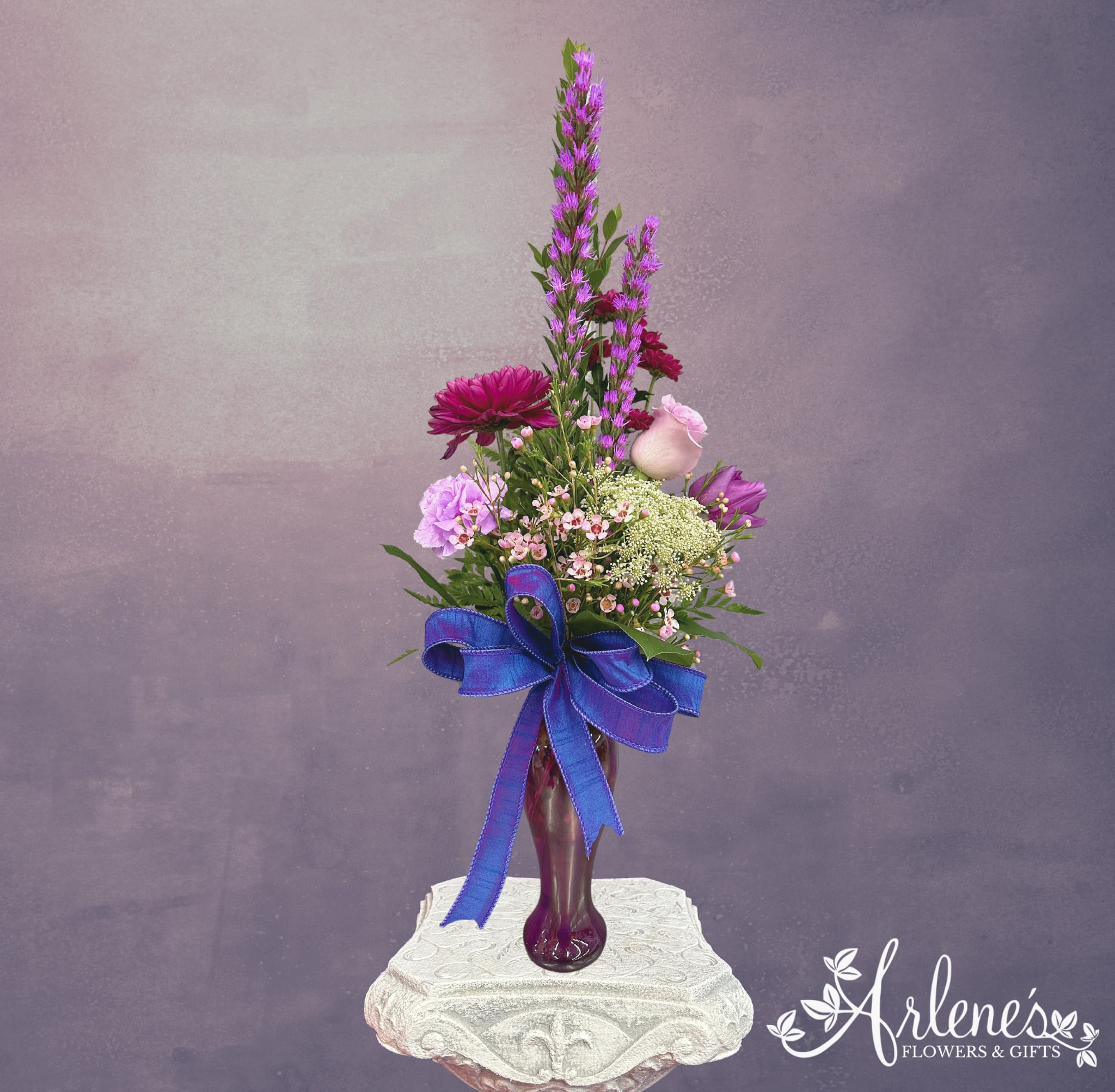 Little Amethyst - Is purple the passion of your princess? Grab her a Lil Amethyst! This sweet budvase will sweep her off her stilettos. A little bit of everything sets this bouquet up to be unique and sweet.