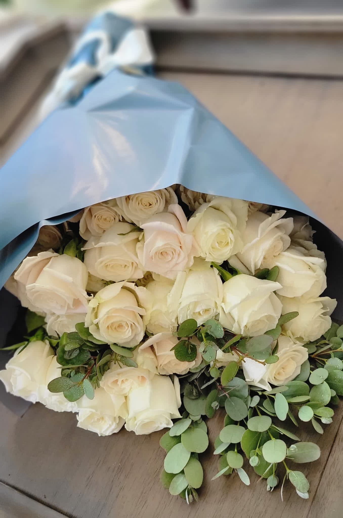 Pure Heart - A hand bouquet with 2 dozen white roses wrapped in decorated paper and ribbon from the honest and pure heart