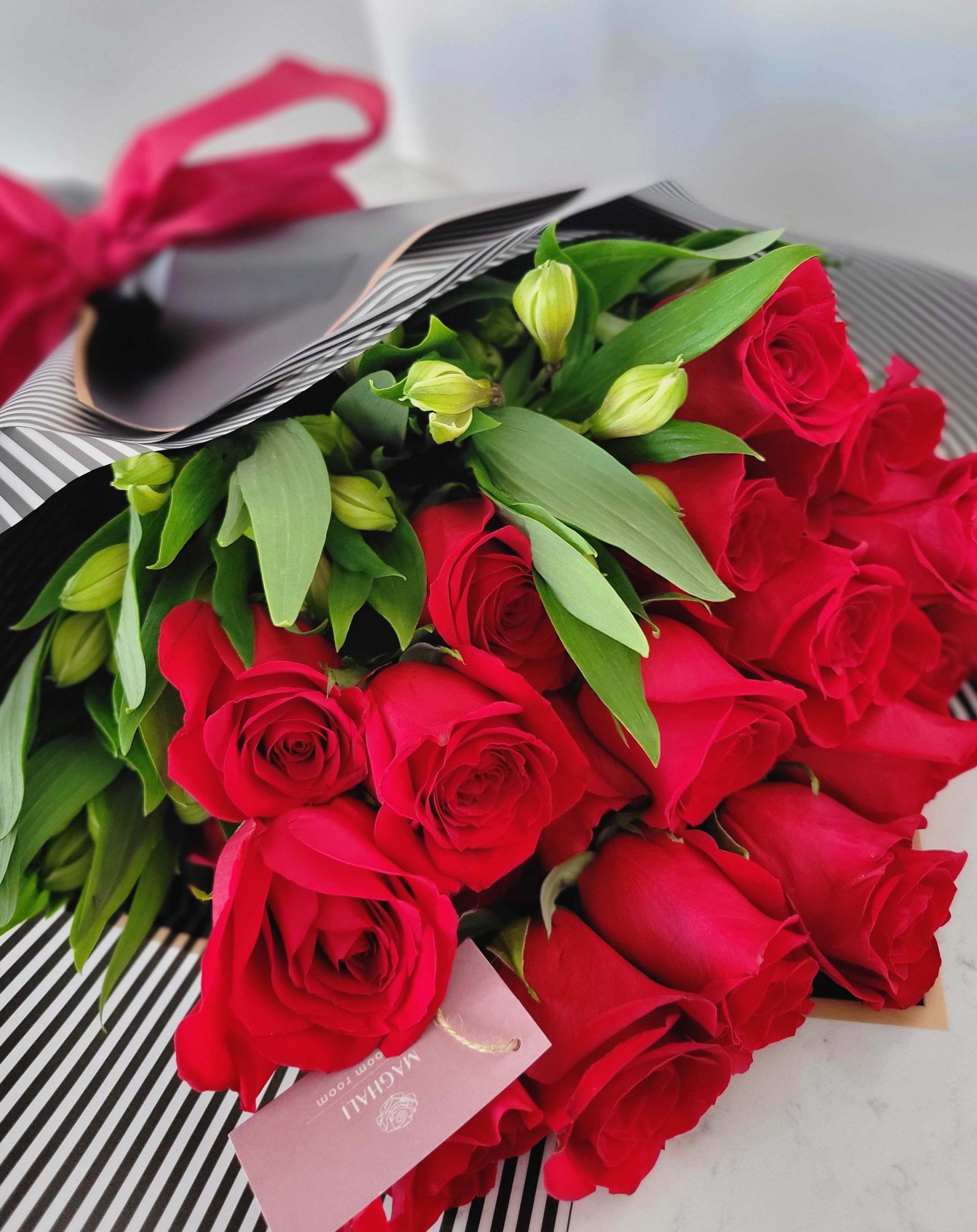I'm Yours - A hand bouquet with 2 dozen of red roses wrapped in decorated paper and ribbon for your loved one 