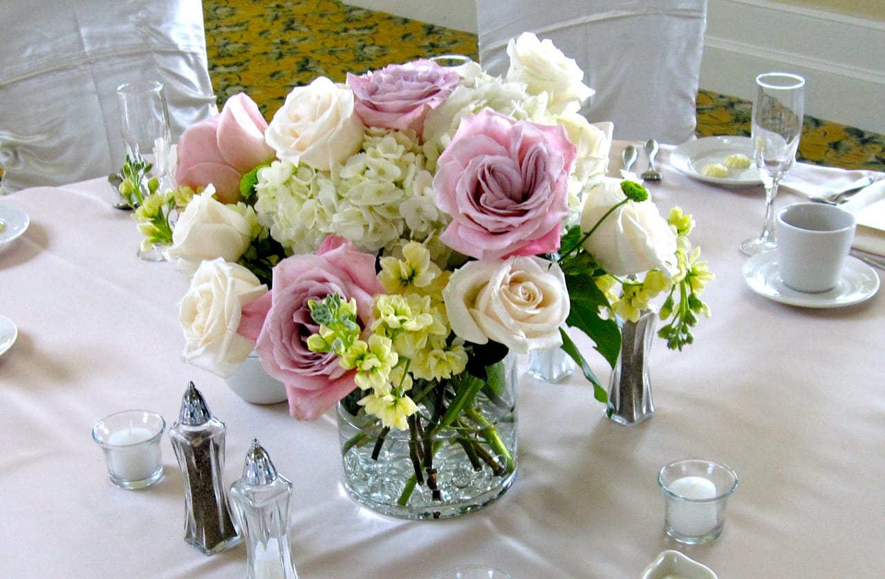 Spring Romance - A beautiful mix of hydrangeas, roses in soft pink and ivory colors, creamy stock and a touch of greenery contained in a glass cylinder vase, lined with glass beads to add support and style. This arrangement makes a great centerpiece.