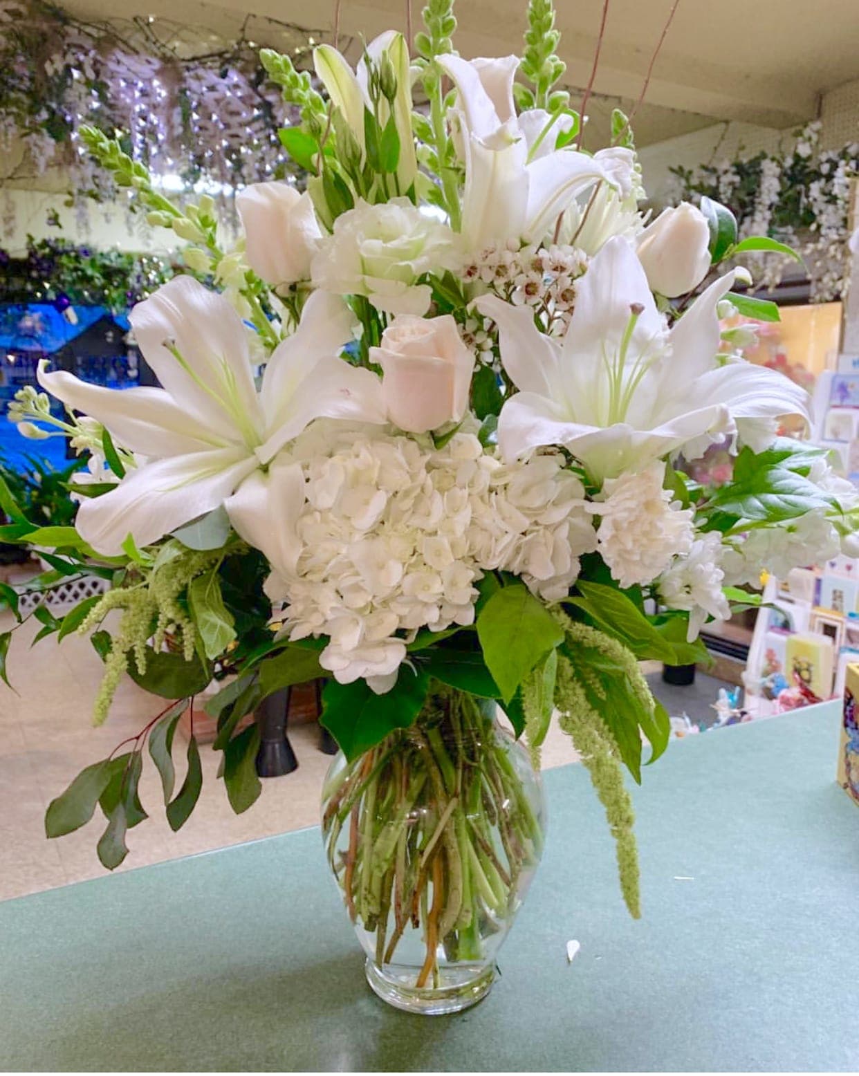 Blessings Blessings - A beautiful all white arrangement. Very lush with several premium blooms in a clear glass vase.