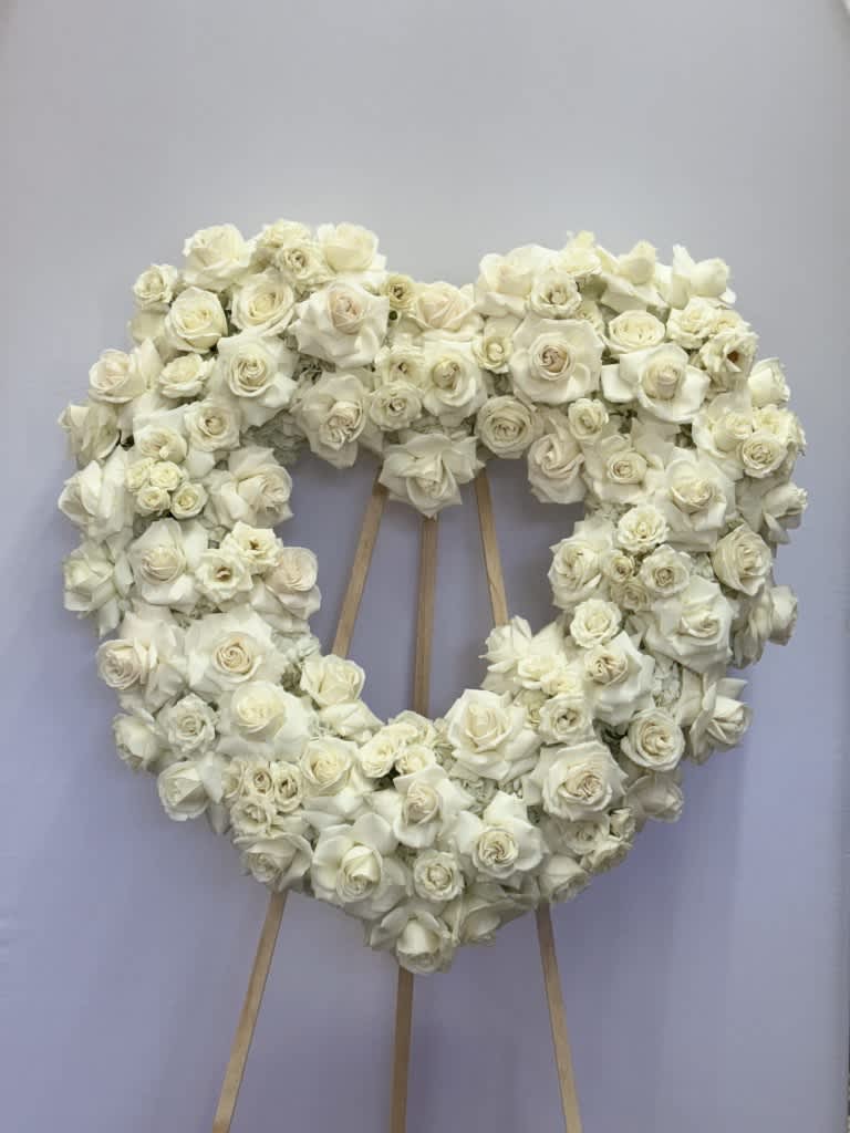 My heart will be with you - This funeral piece is a open heart with all white floral; roses, spray roses, and hydrangea.