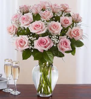 THE ELEGANT PINK ROSE BOUQUET - Our elegant long stem premium pink roses are a surprise for the one you can trust, the one you can turn to, the one you love with all your heart. Beautifully arranged by our expert florists with lush greenery inside a classic glass vase,12,18 or 24 radiant blooms are hand-delivered and ready to delight them for any romantic reason. (DELUXE 18ct SHOWN)  Available in Red, Pink or Mixed colors. Just add your preference in the order details