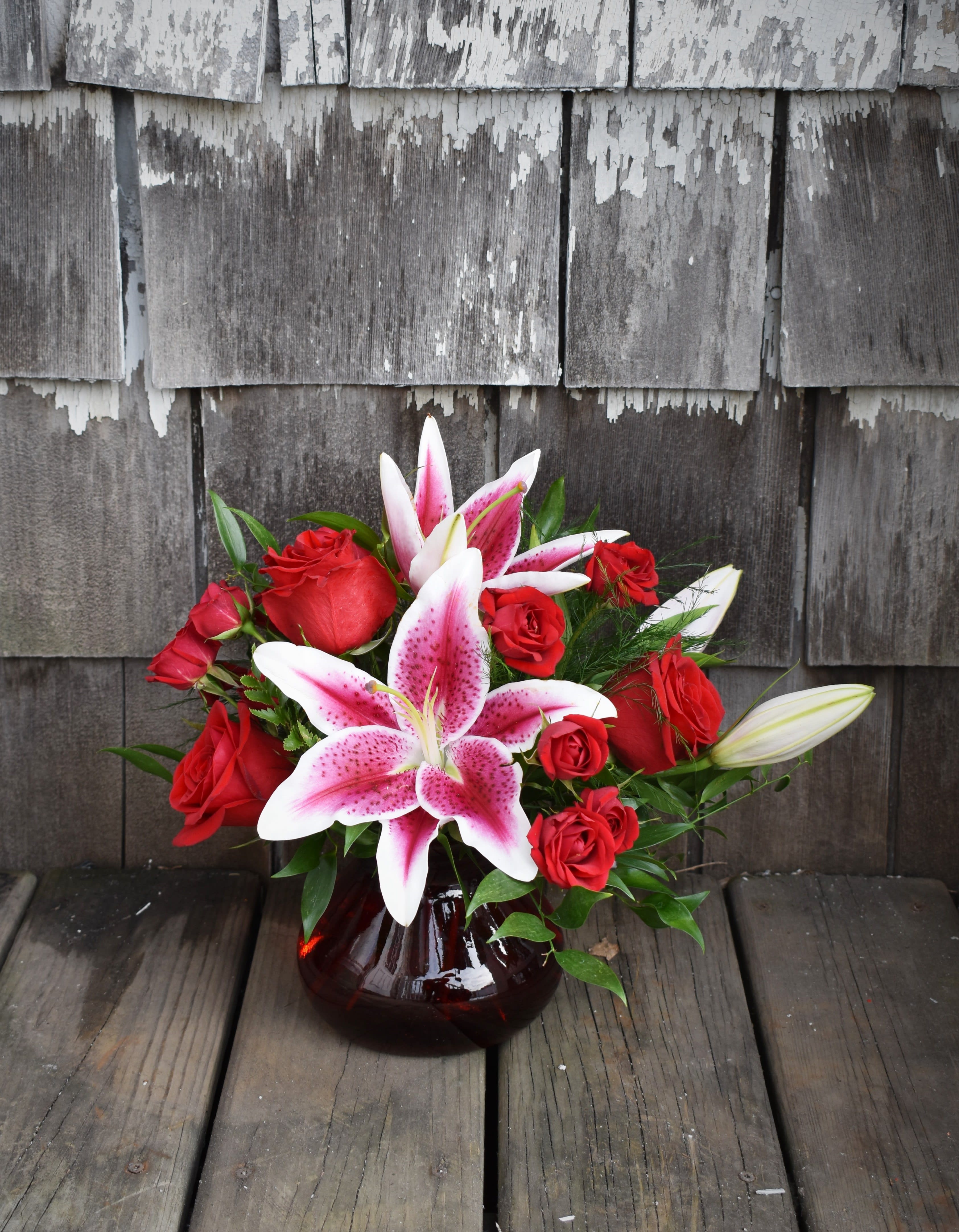 Summer Rose - A ruby-toned vase is full of crimson roses, spray roses, and vibrant Stargazer lilies! Perfect to show your love for that special someone! 