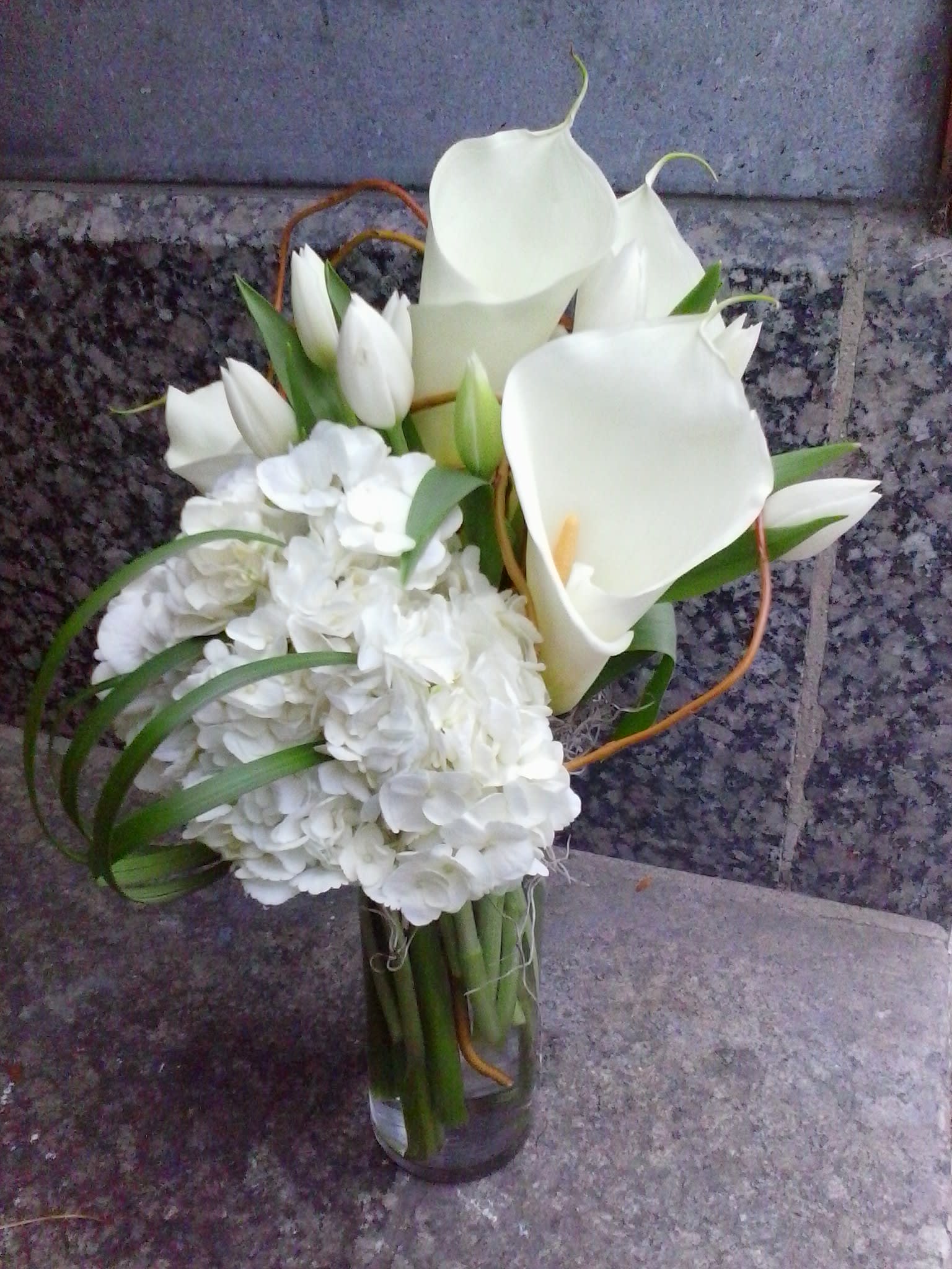 Modern Whites Modern Whites - Full size, open cut white callas arranged in modern groupings along with Dutch tulips and South American hydrangeas