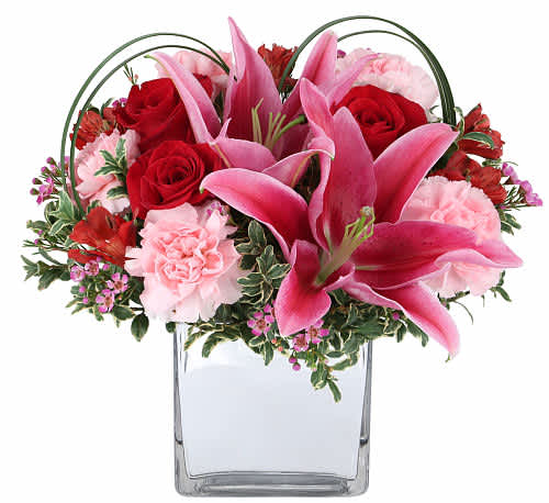 captured your heart bouquet  - Make a statement this Valentine’s Day by giving this uniquely inspired gift that will surely make their day special. Arranged in a reflective cube vase with red tones, pink lilies and fresh greens. A perfect sentiment to send from your heart to theirs.