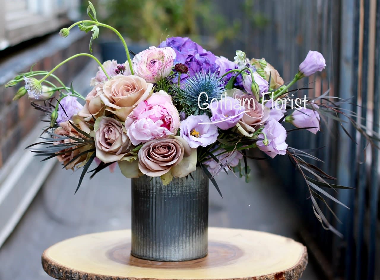 Lavender Princess - Soft lavender and purple flowers in rustic tin vase. Send unique, gorgeous flowers from the best florist in manhattan NY.